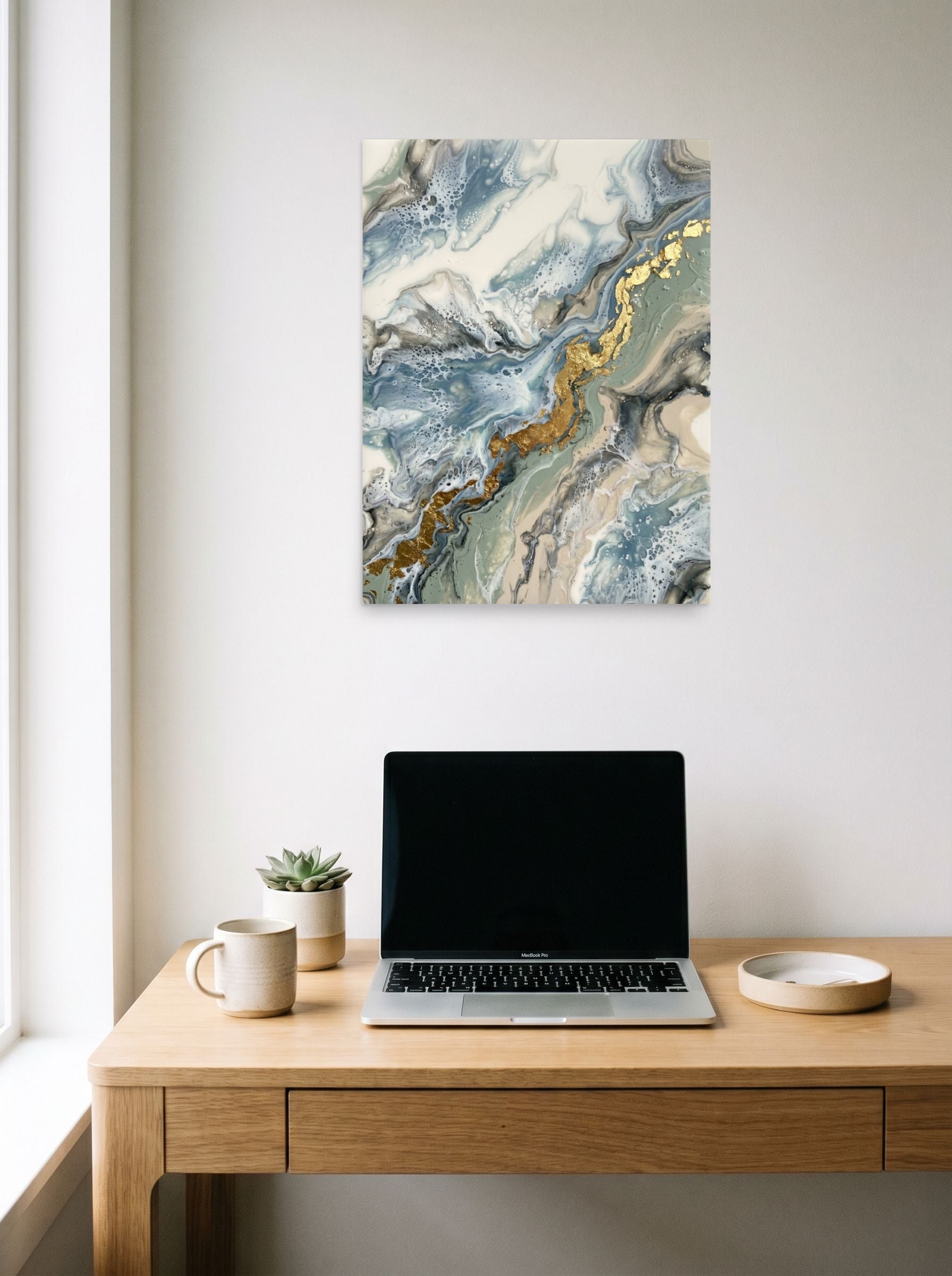 A 18x24 inch unframed paper Abstract art print of 'Golden Fracture' hanging above a worktable with a laptop.