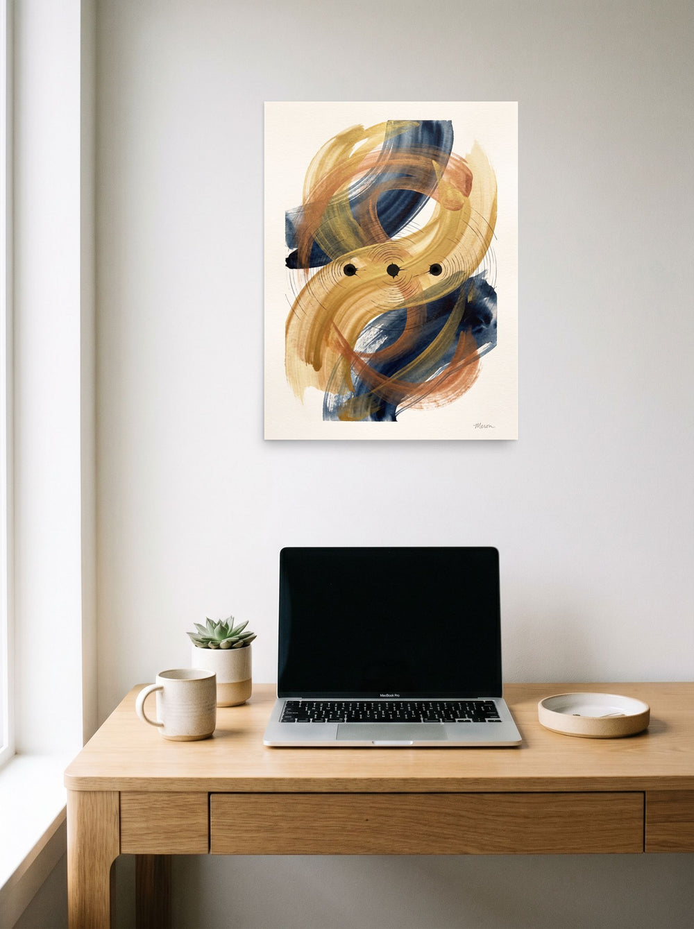 A 18x24 inch unframed paper version of 'Orbital Equilibrium', Abstract expressionism wall art, hanging above a worktable with a laptop.