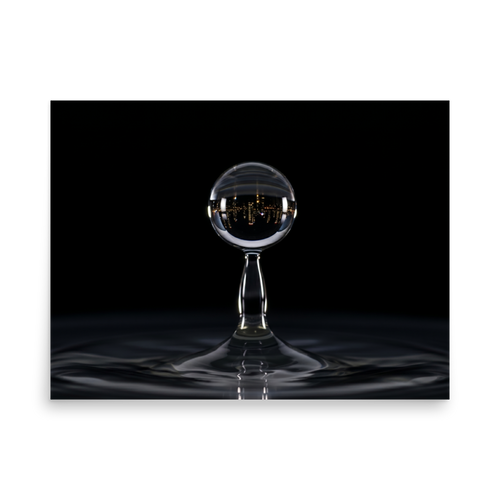'City in a Drop' — a Surrealism print. A macro view of a water droplet splashing, containing an inverted reflection of a glowing city skyline at night.