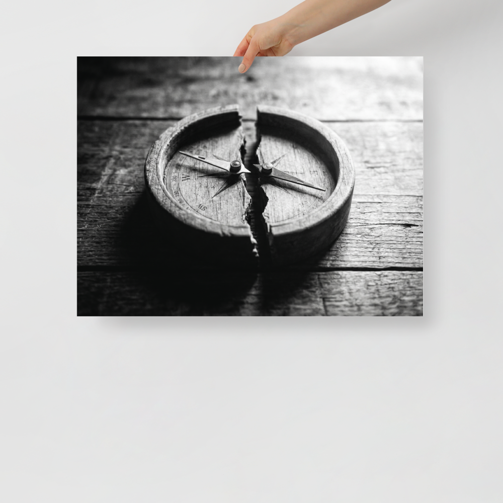 'Lost Direction' — a Art photography print. Dramatic black and white photograph of an antique wooden compass cracked entirely in half on a textured table, ideal for an office or library.