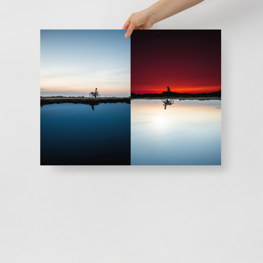 'Two Worlds Riding' — a Surrealism print. A split horizon image showing a cyclist riding in twilight blue on top and an inverted red sunset on the bottom.