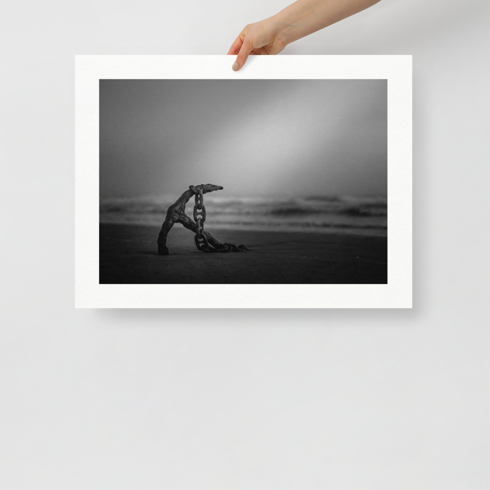 'The Old Anchor' — a Art photography print. A moody black and white photograph of an old rusted anchor and chain resting on a misty beach, a striking nautical piece for a Bathroom.