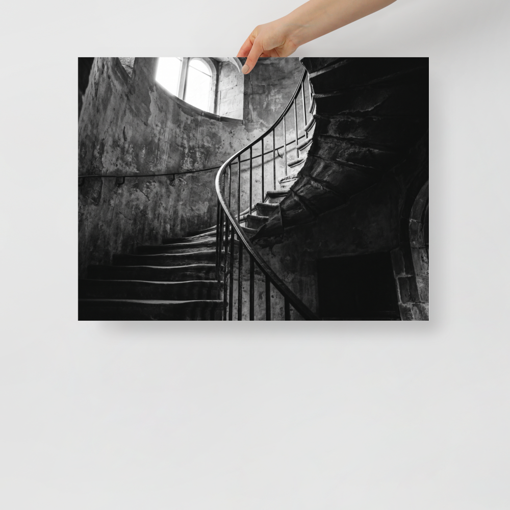 'Ascending Shadows' — a Art photography print. A black and white photograph of a winding stone staircase bathed in dramatic natural light, an elegant focal point for a Hallway.