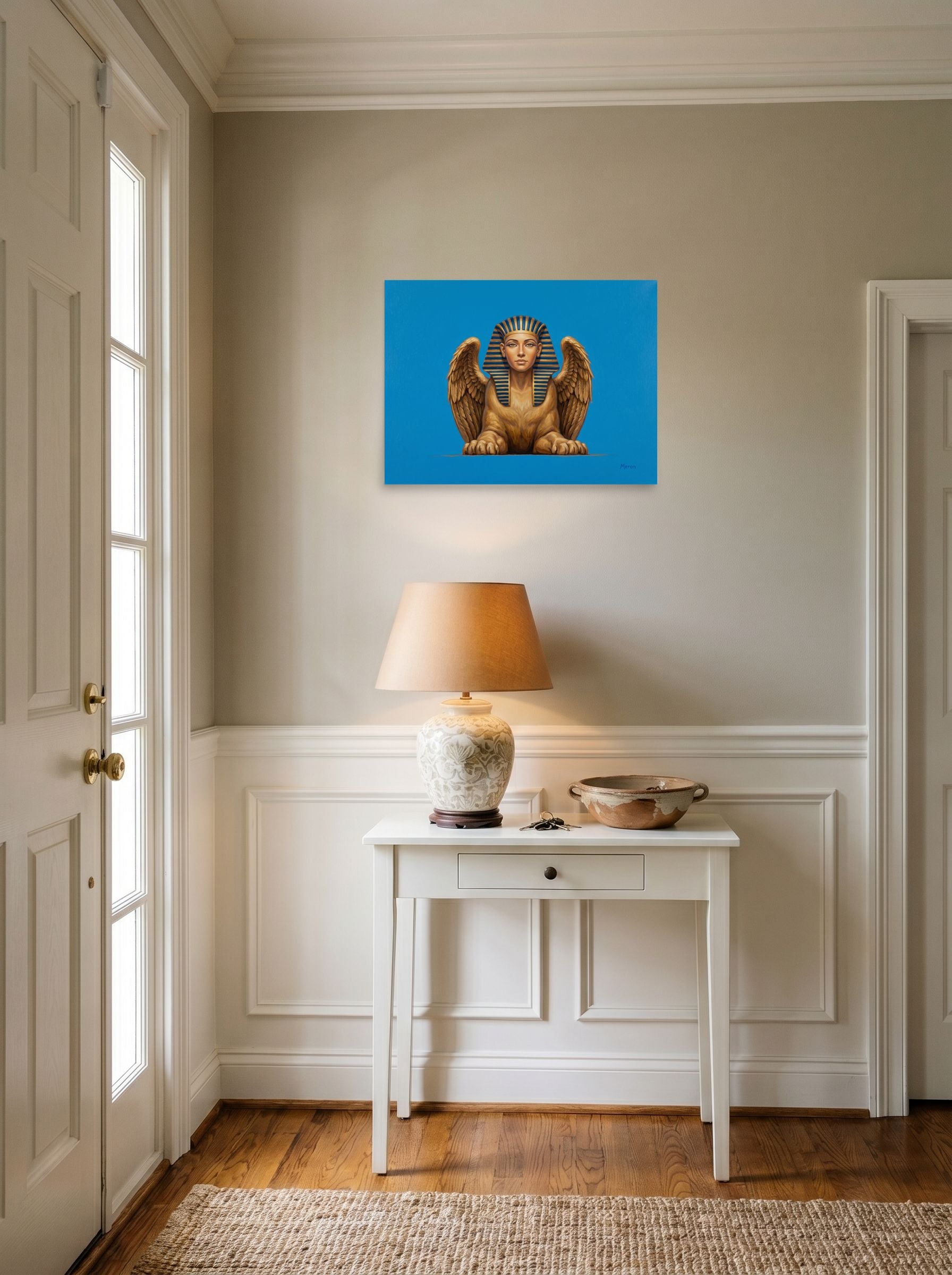 A 24x18 inch unframed paper Realism print of 'The Golden Sphinx' hanging in an entryway near a console.