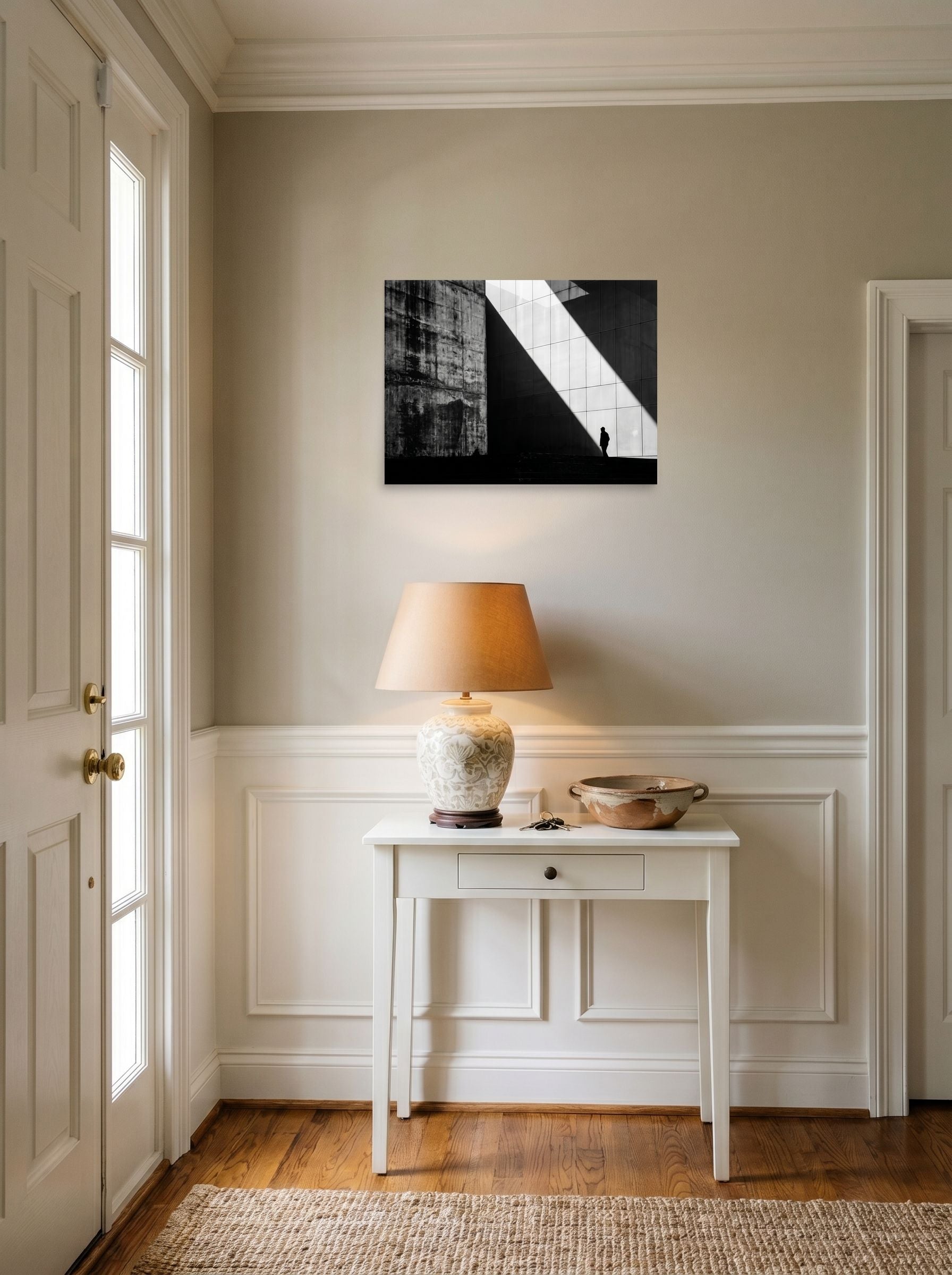 A 24x18 inch unframed paper Modernism print of 'Urban Geometry' hanging in an entryway near a console.