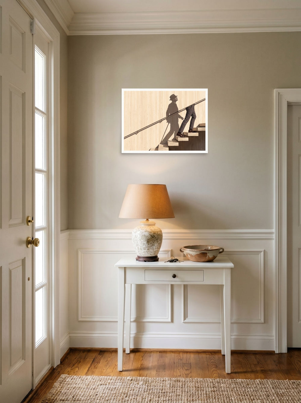 A 24x18 inch unframed paper Surrealism,Realism print of 'Ascent of the Shadow' hanging in an entryway near a console.