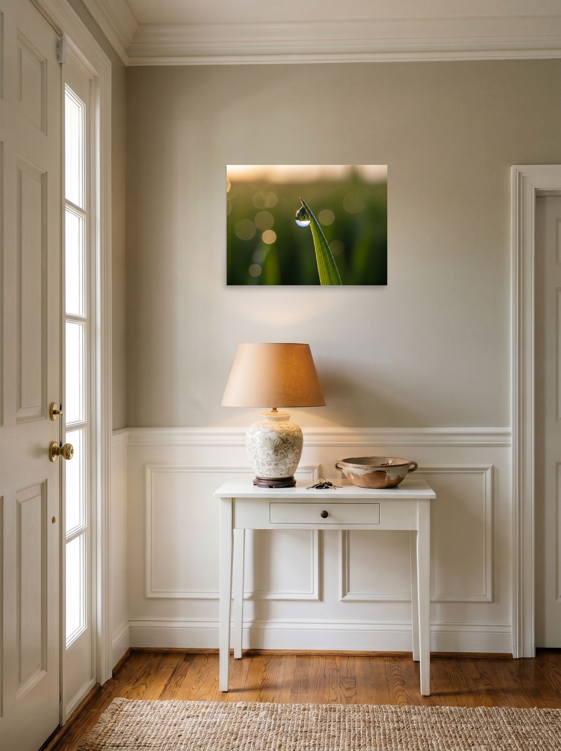 A 24x18 inch unframed paper Art photography print of 'World in a Drop' hanging in an entryway near a console.