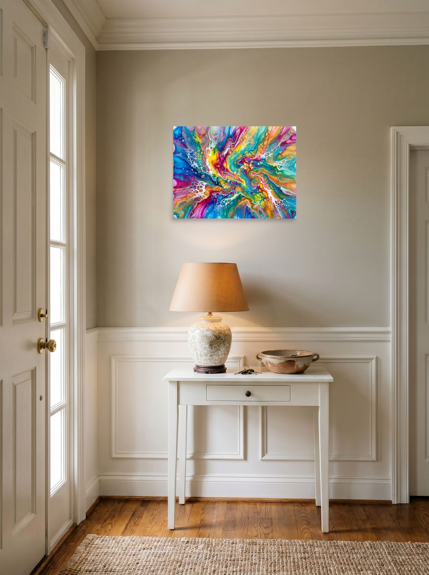 A 24x18 inch unframed paper Abstract art print of 'Rainbow Burst' hanging in an entryway near a console.