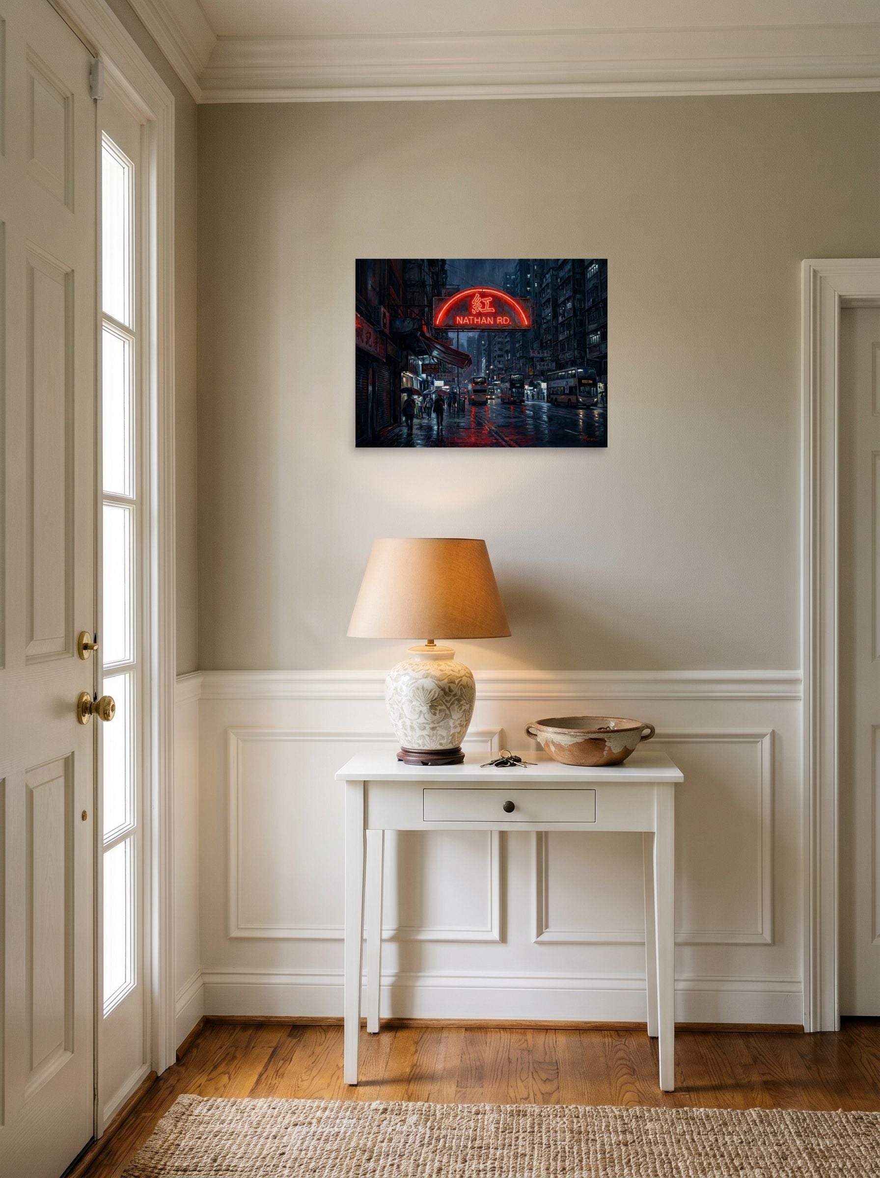 A 24x18 inch unframed paper Realism print of 'Rainy Night on Nathan Road' hanging in an entryway near a console.