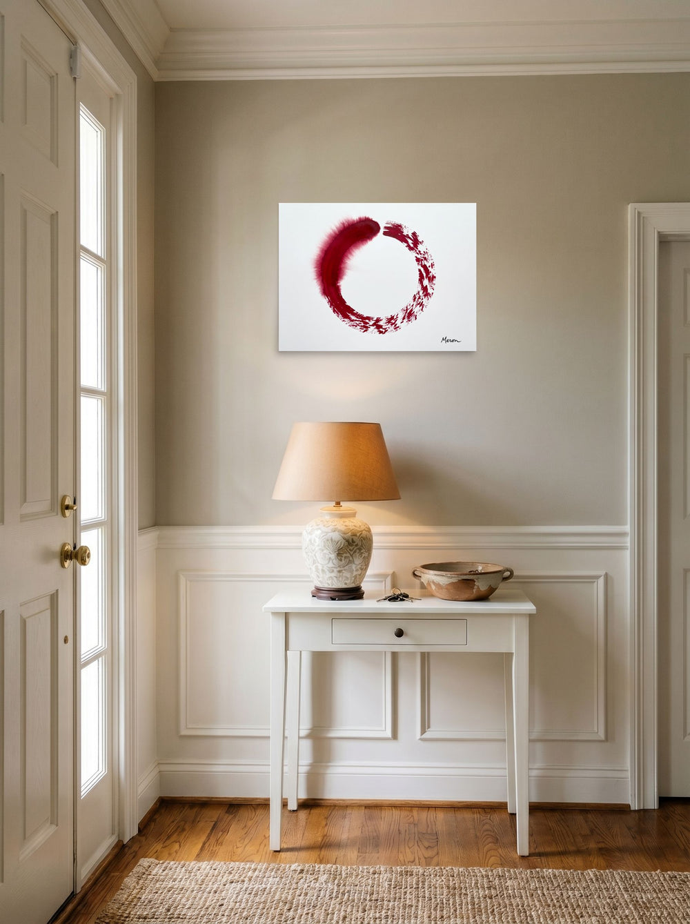 A 24x18 inch unframed paper Minimalism,Abstract expressionism print of 'Crimson Enso' hanging in an entryway near a console.