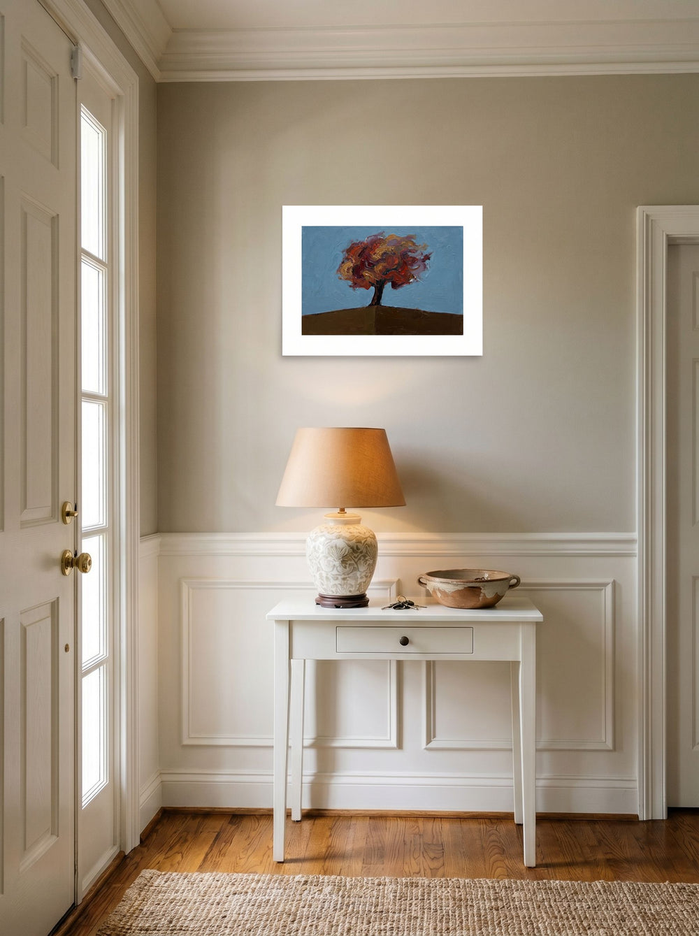 Mockup of 'The Lone Autumn' as a 24x18 inch unframed paper print, hanging in an entryway near a console.
