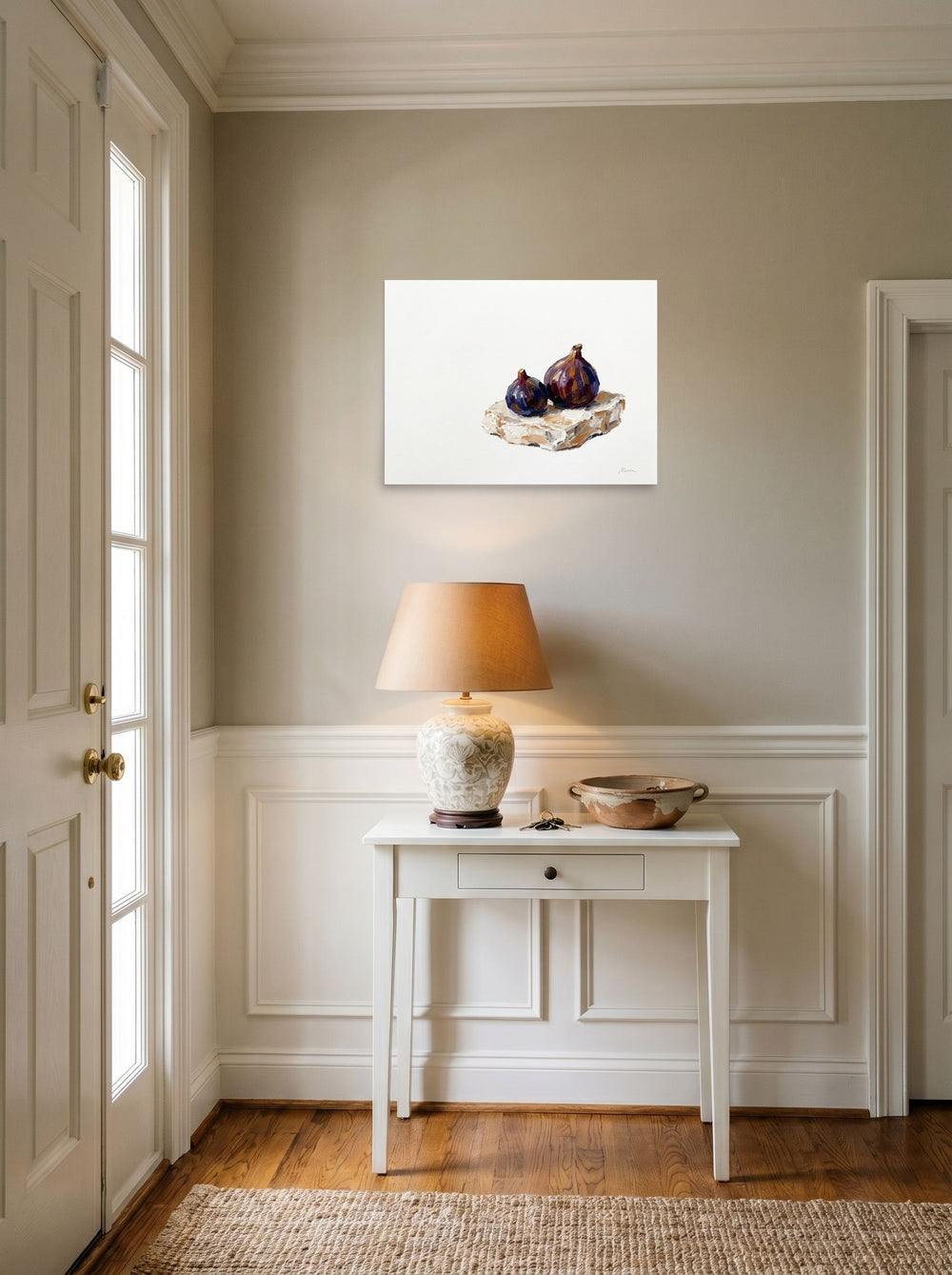 A 24x18 inch unframed paper Realism,Modernism print of 'Ripe Figs on Cream' hanging in an entryway near a console.