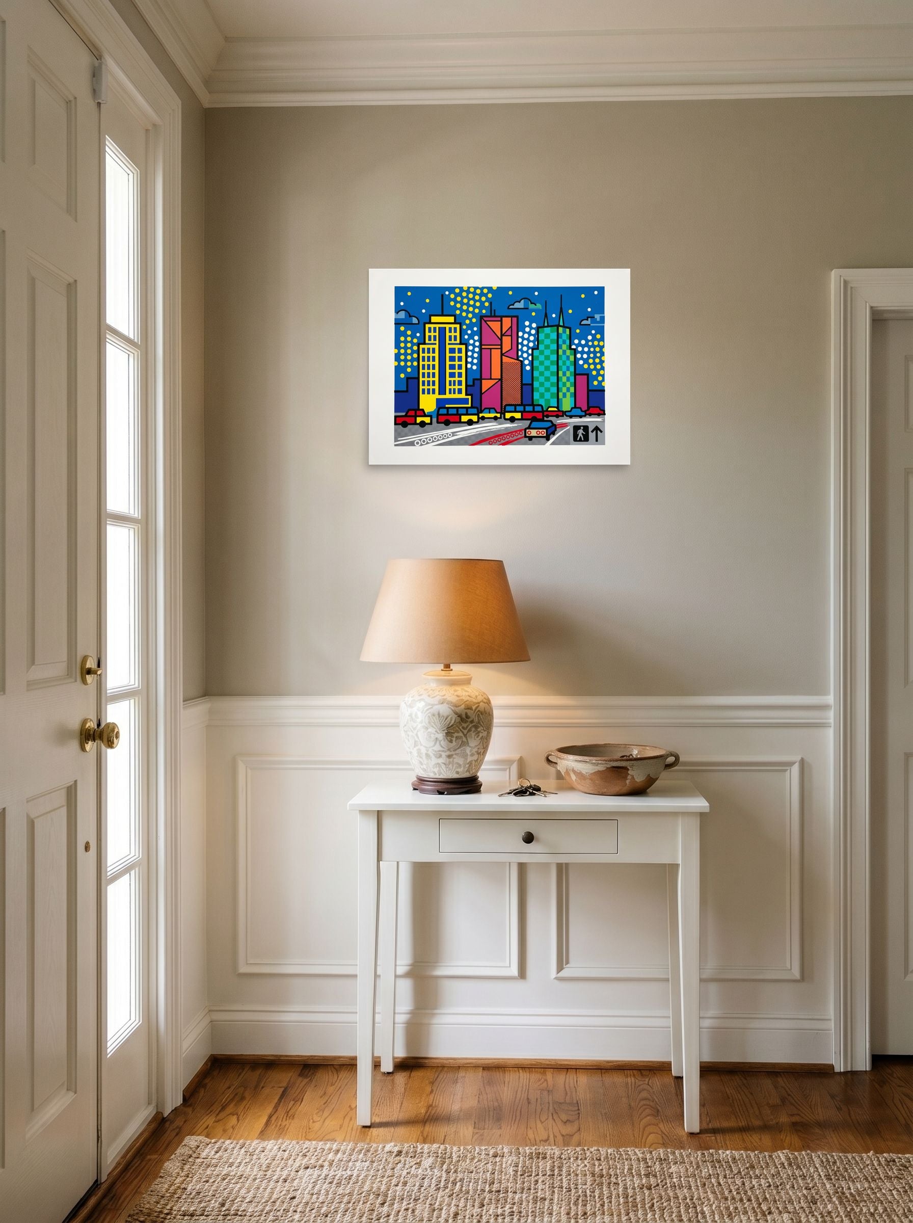 A 24x18 inch unframed paper Pop art print of 'City Commute Pop' hanging in an entryway near a console.