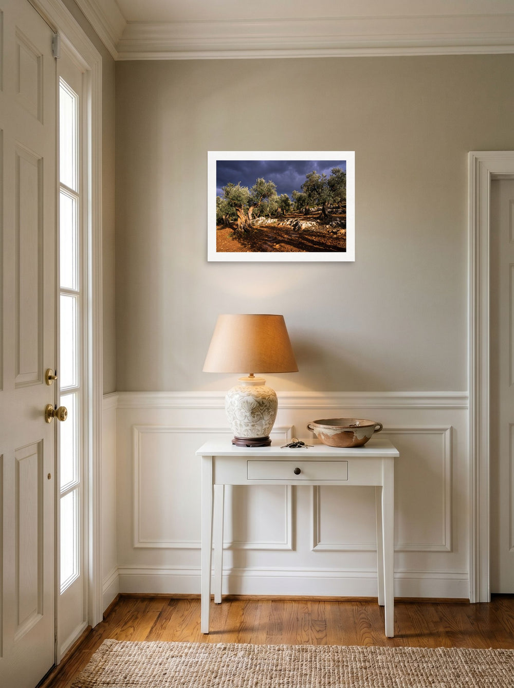 A 24x18 inch unframed paper Art photography print of 'Storm Over the Olive Grove' hanging in an entryway near a console.