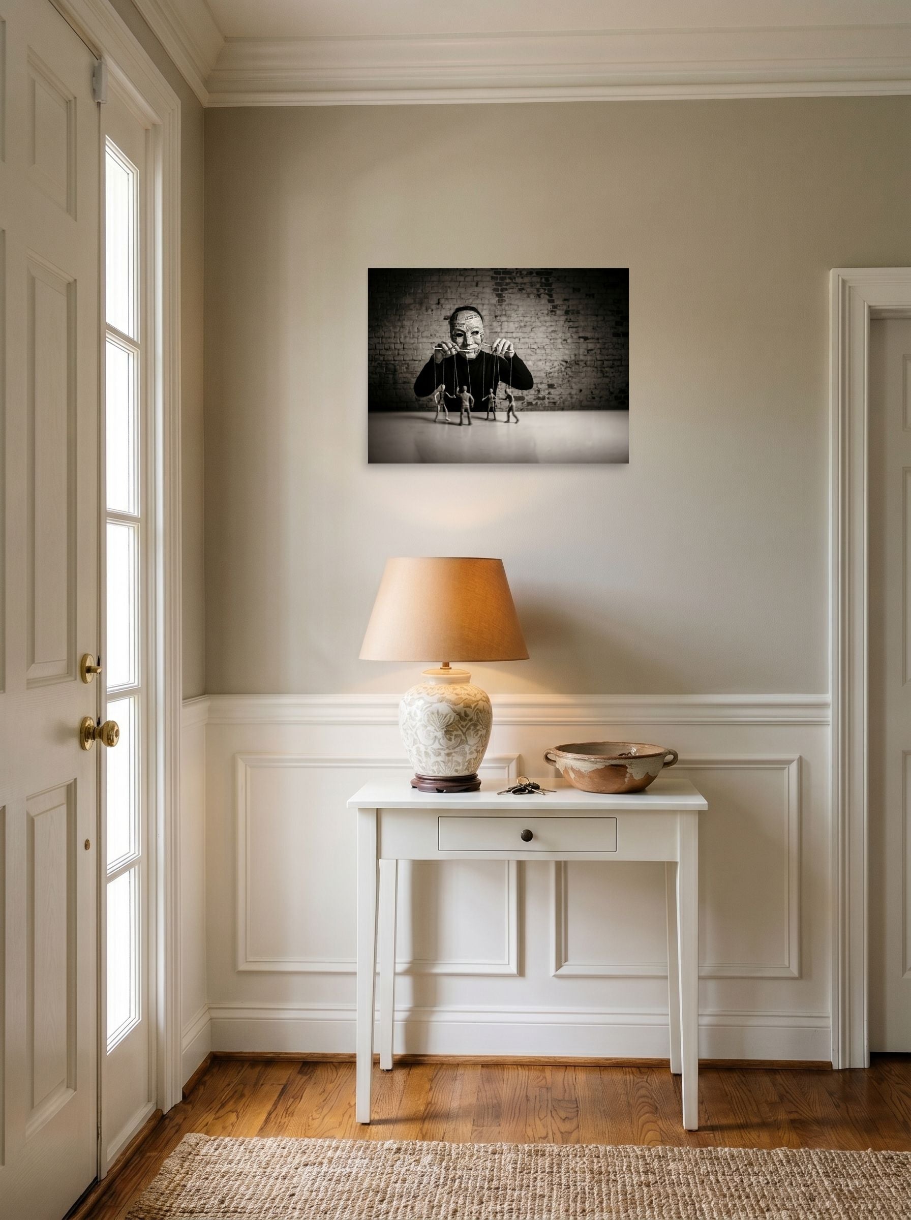 A 24x18 inch unframed paper Surrealism print of 'The Puppeteer of News' hanging in an entryway near a console.