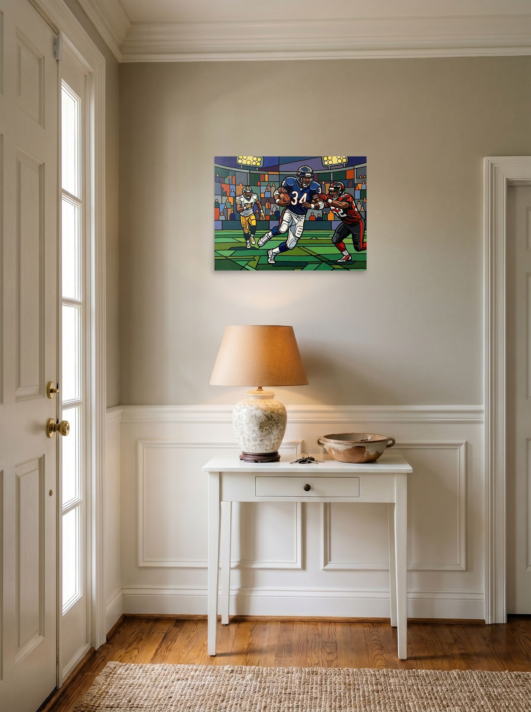 A 24x18 inch unframed paper Cloisonnism print of 'The Breakaway Run' hanging in an entryway near a console.