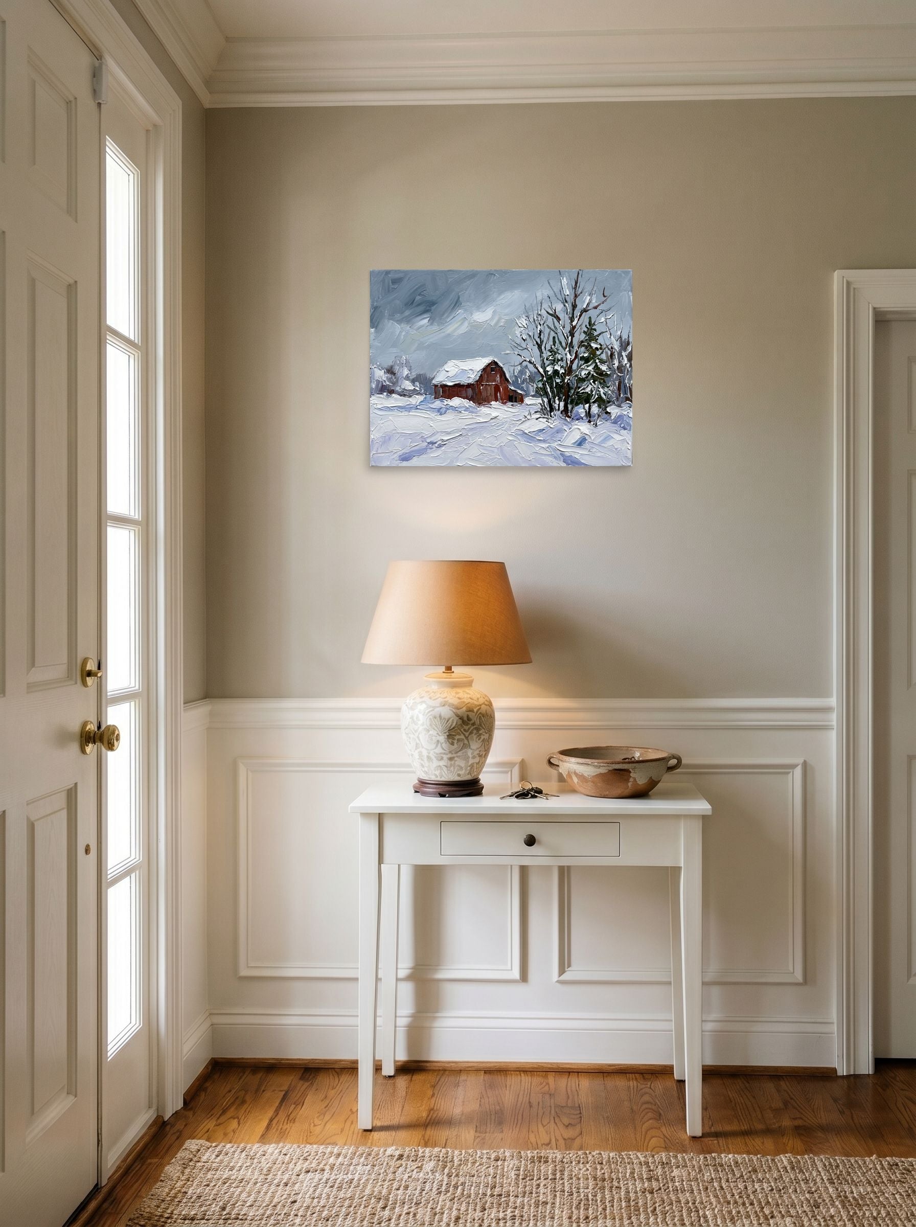 A 24x18 inch unframed paper Impressionism print of 'Winter at the Red Barn' hanging in an entryway near a console.