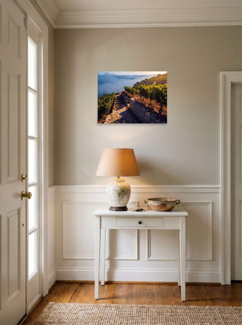 A 24x18 inch unframed paper Art photography print of 'Vineyard Above the Clouds' hanging in an entryway near a console.