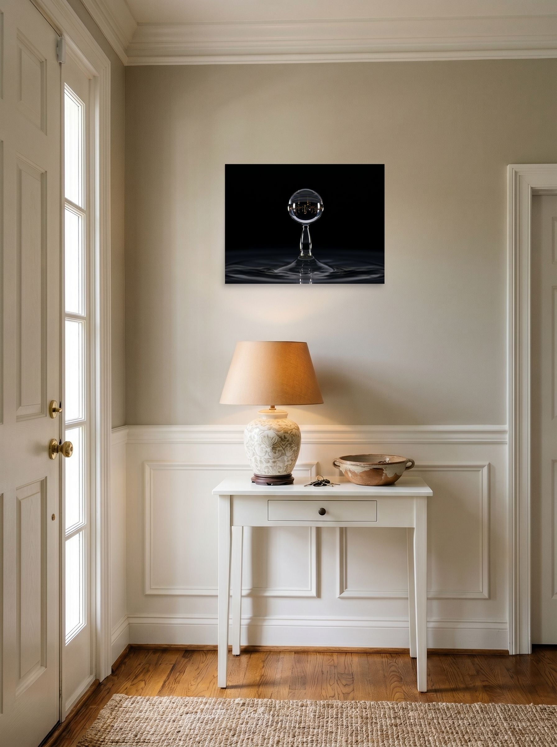 A 24x18 inch unframed paper Surrealism print of 'City in a Drop' hanging in an entryway near a console.
