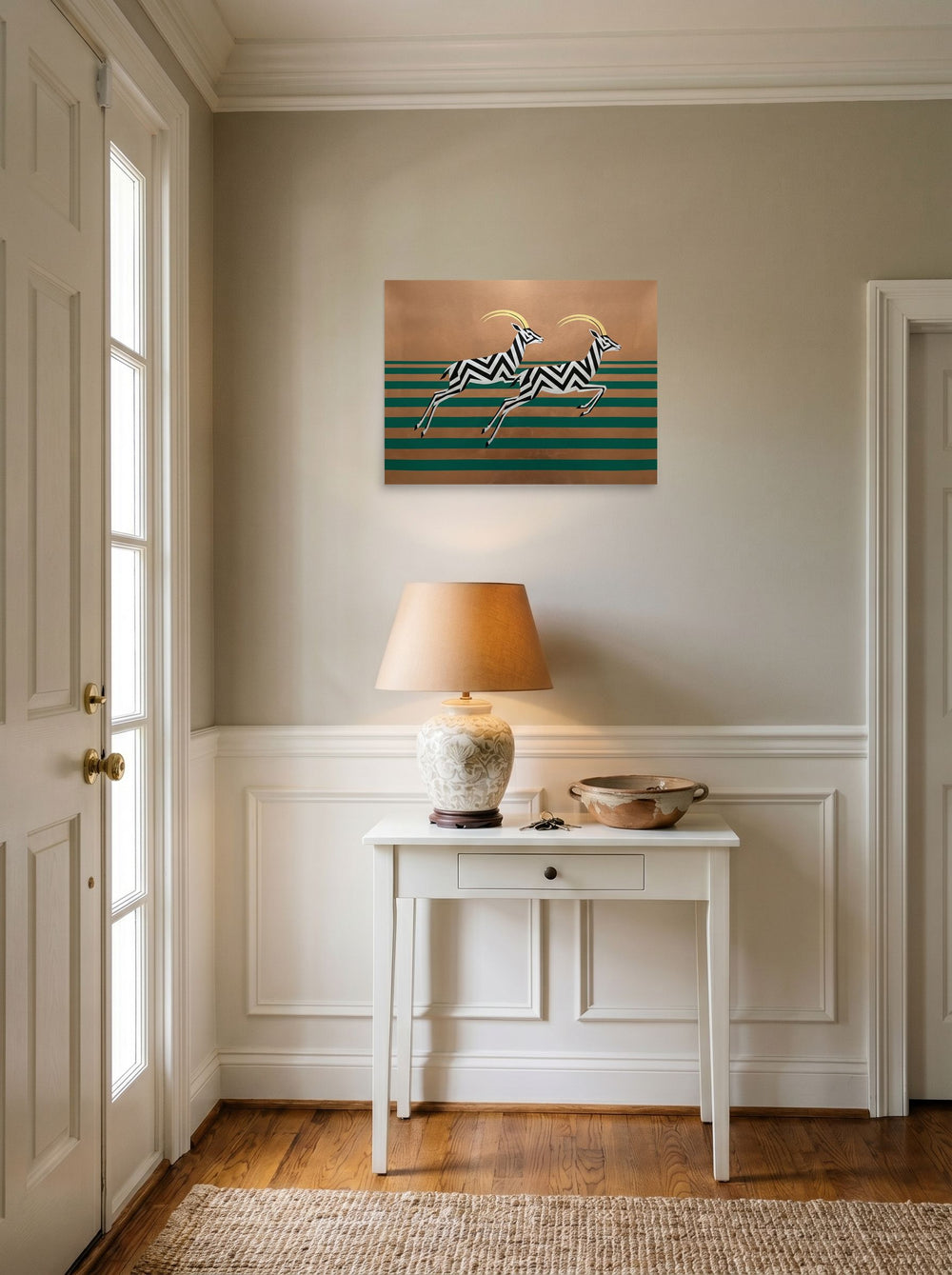 A 24x18 inch unframed paper Art Deco print of 'Golden Gazelles' hanging in an entryway near a console.