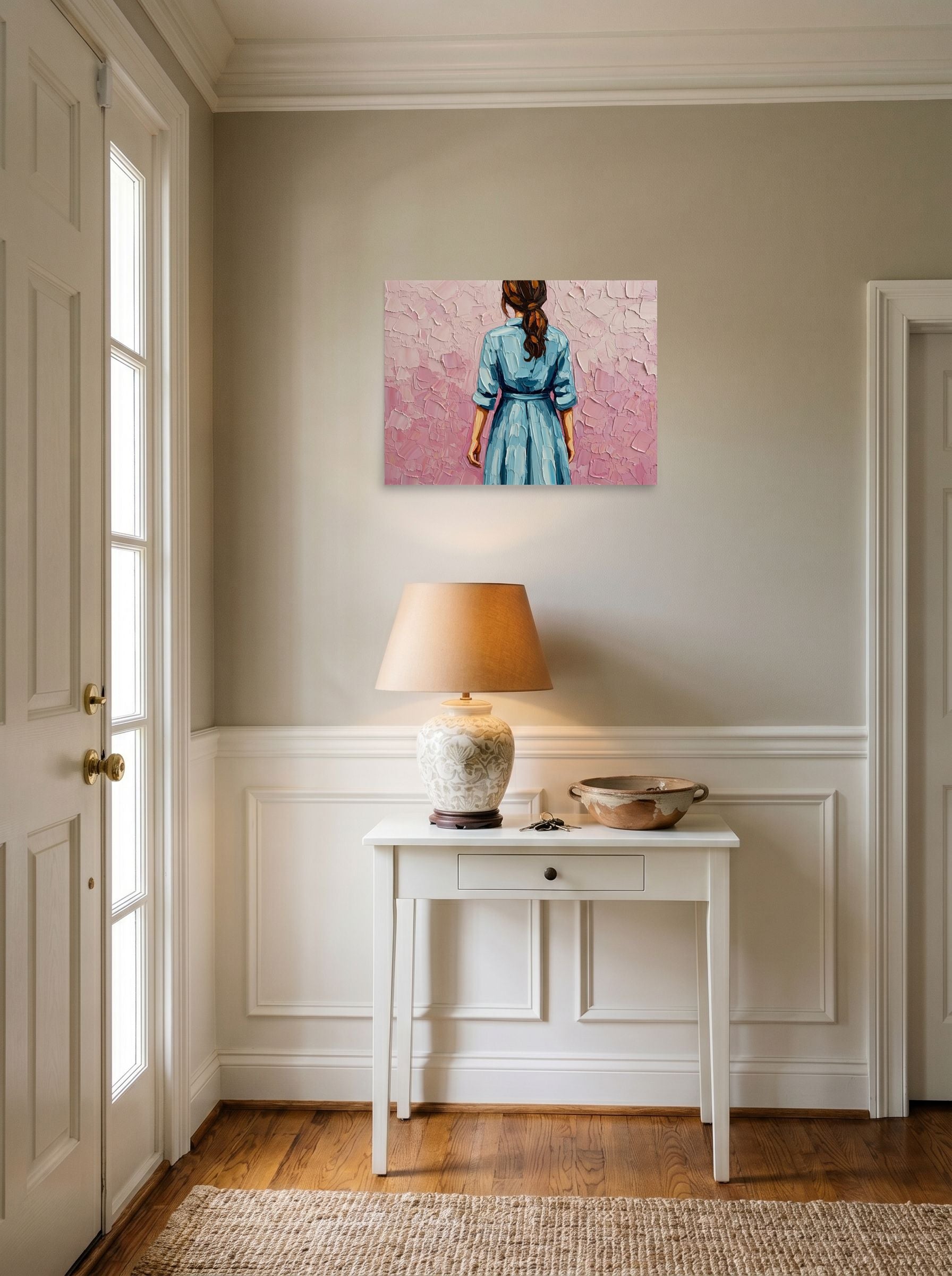 A 24x18 inch unframed paper Figurative art print of 'The Blue Dress' hanging in an entryway near a console.