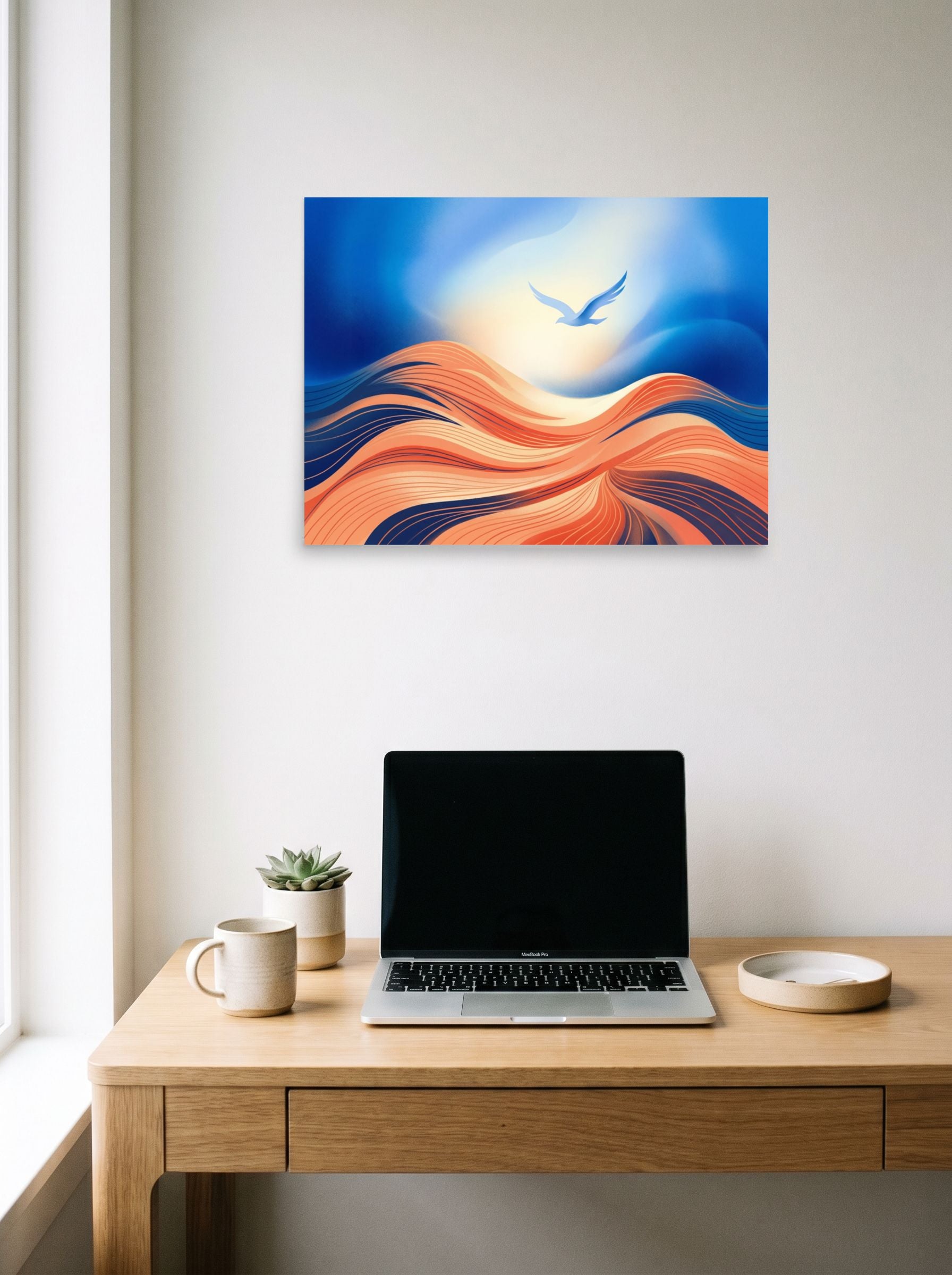 A 24x18 inch unframed paper Abstract art print of 'Flight Over the Dunes' hanging above a worktable with a laptop.