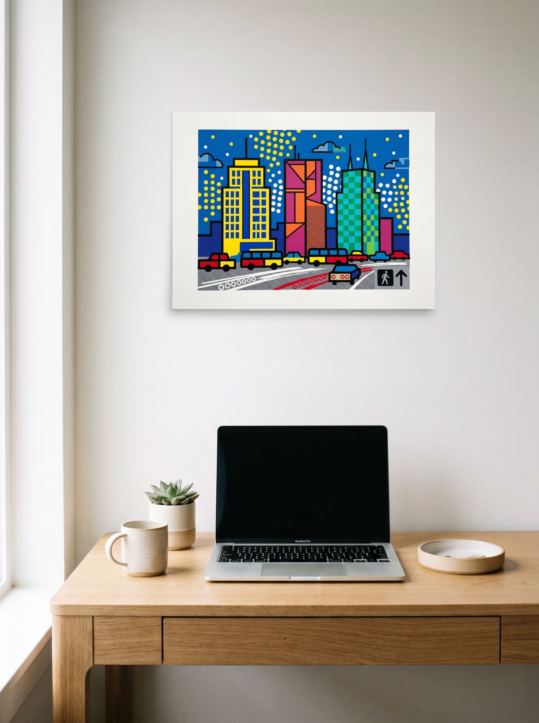 A 24x18 inch unframed paper Pop art print of 'City Commute Pop' hanging above a worktable with a laptop.