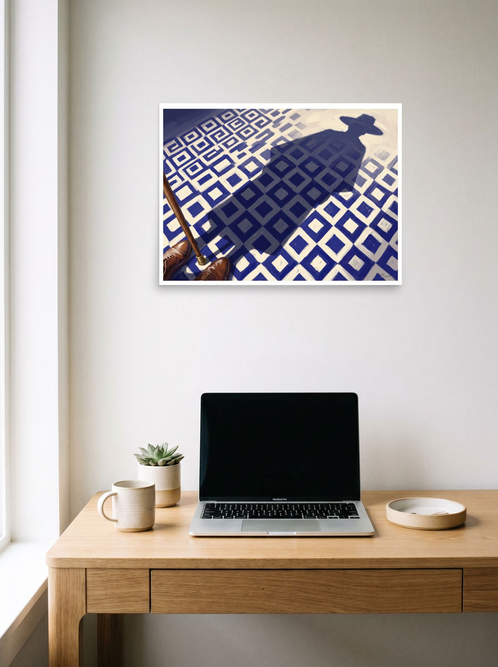 A 24x18 inch unframed paper Realism,Magic realism print of 'Shadow of the Traveler' hanging above a worktable with a laptop.