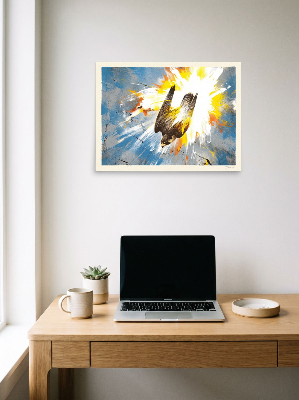 A 24x18 inch unframed paper version of 'Terminal Stoop', Pop art wall art, hanging above a worktable with a laptop.