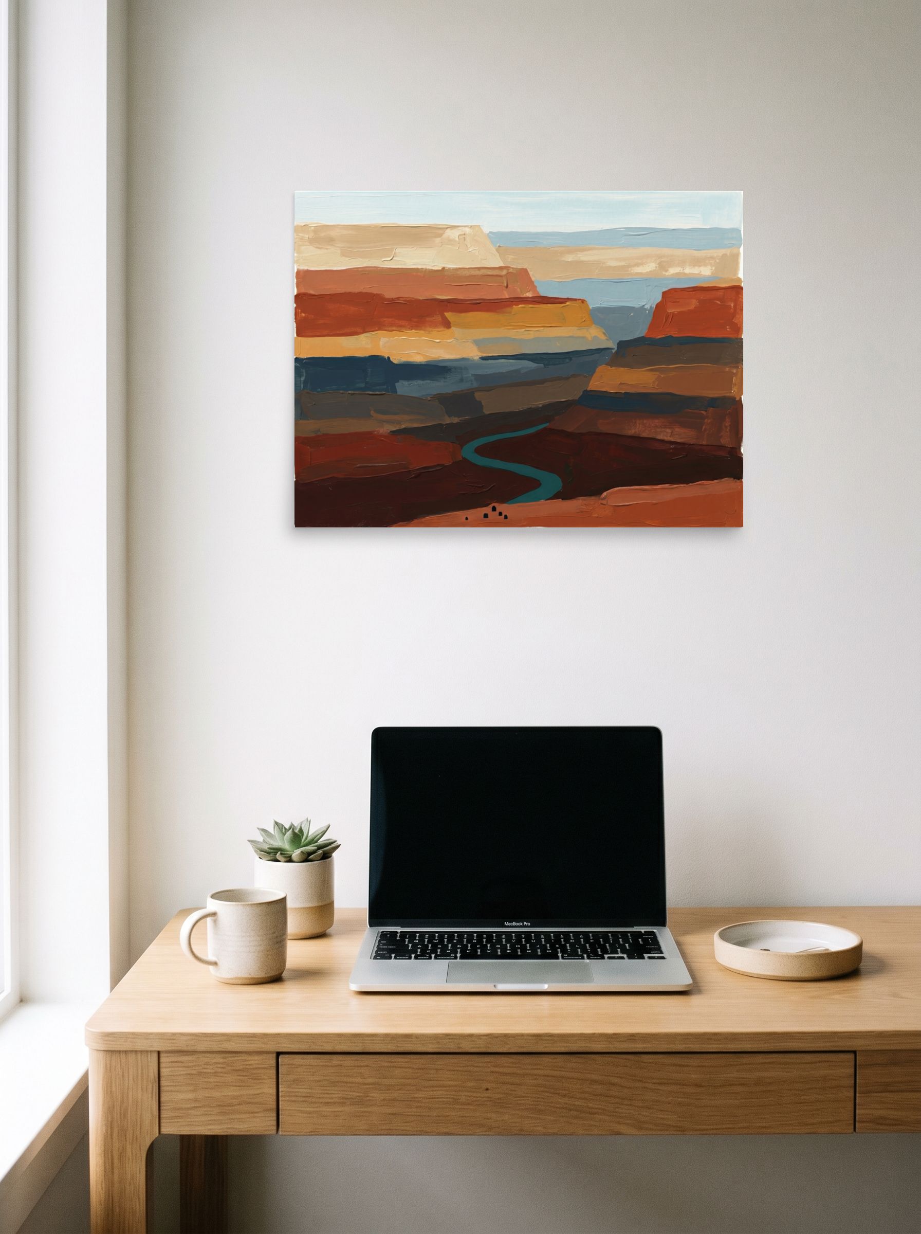 A 24x18 inch unframed paper Expressionism,Impressionism print of 'Deep Canyon River' hanging above a worktable with a laptop.