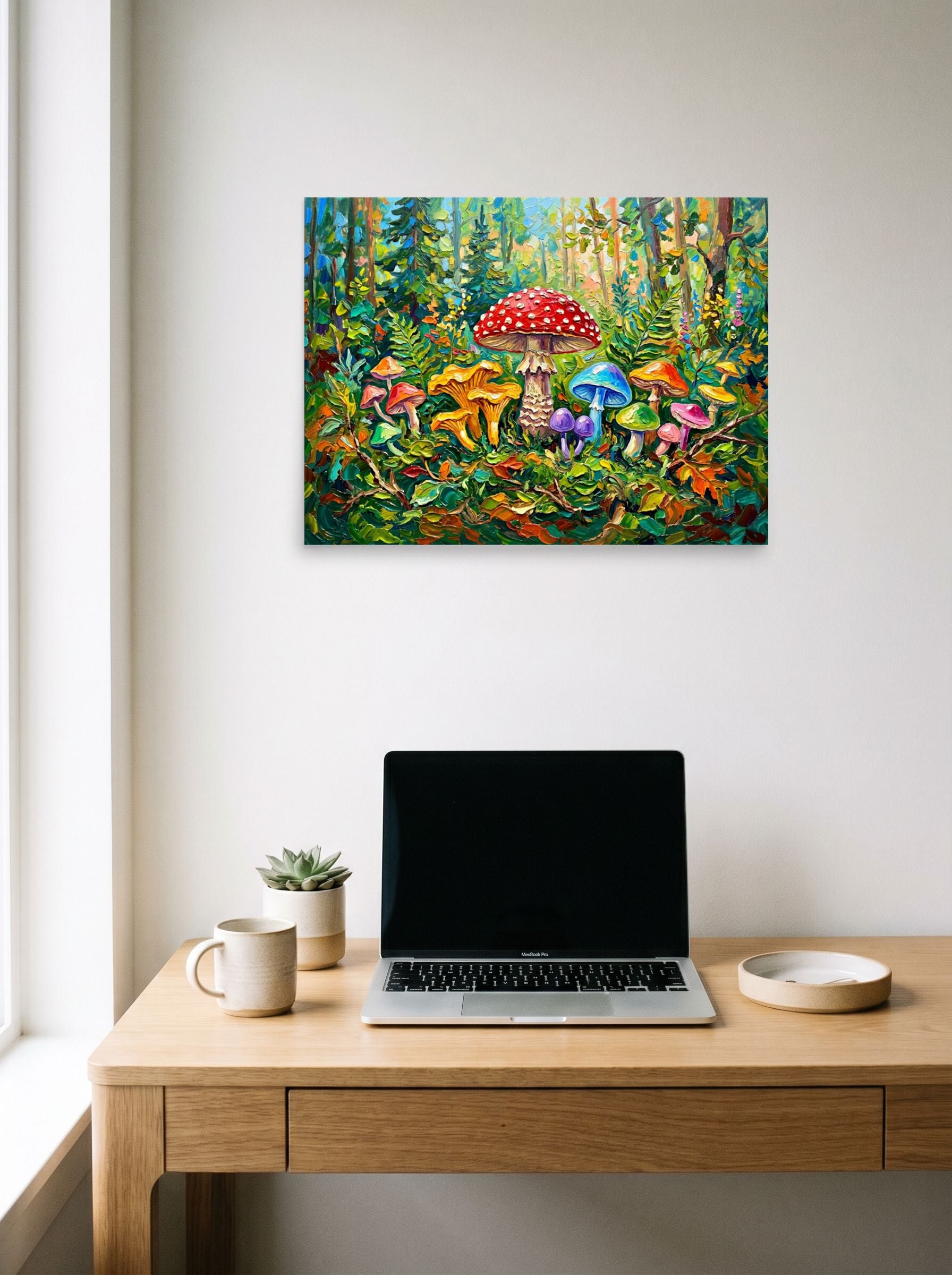 A 24x18 inch unframed paper Fauvism print of 'The Enchanted Grove' hanging above a worktable with a laptop.
