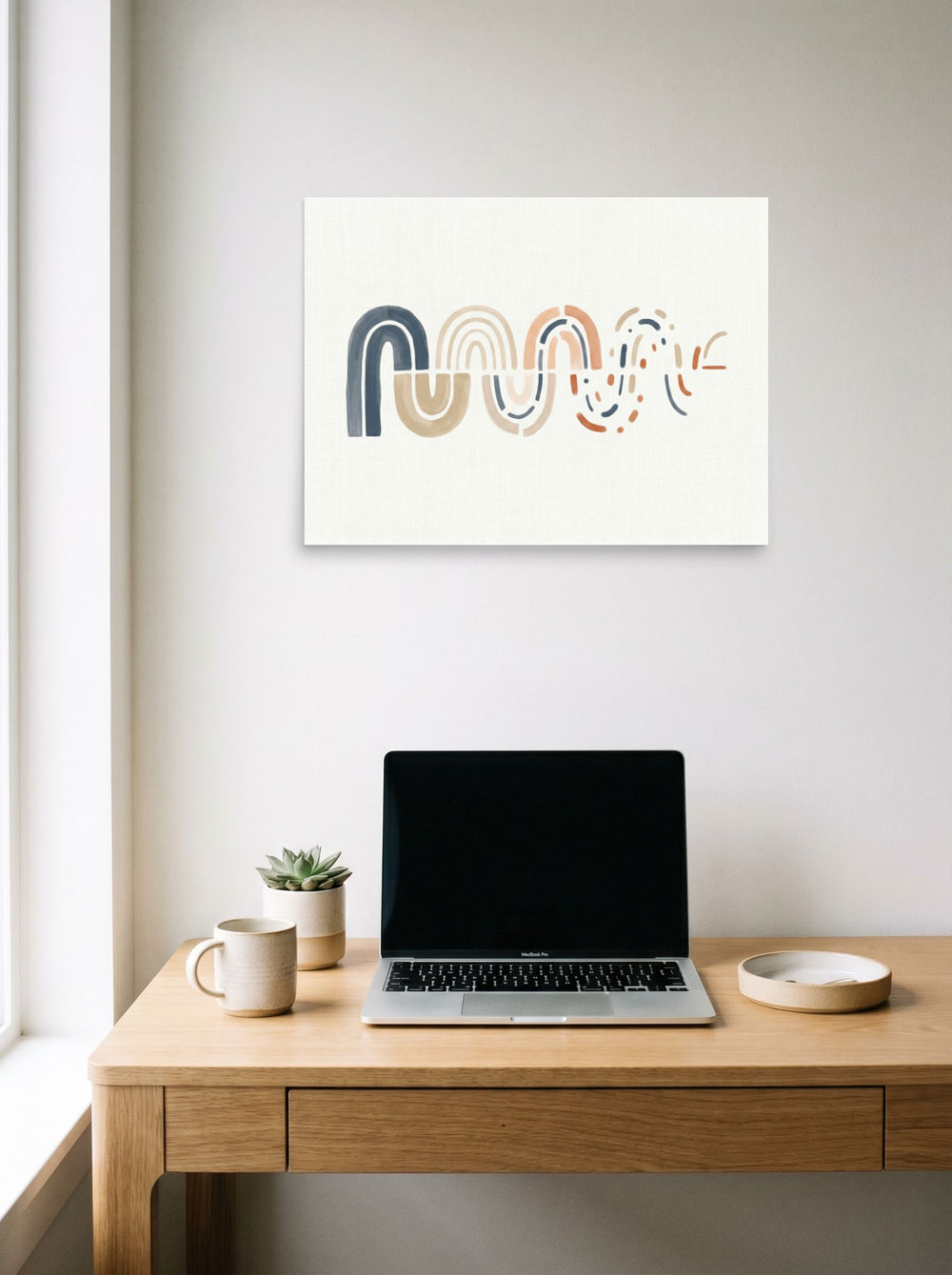 A 24x18 inch unframed paper Minimalism,Abstract art print of 'Unraveling Waves' hanging above a worktable with a laptop.
