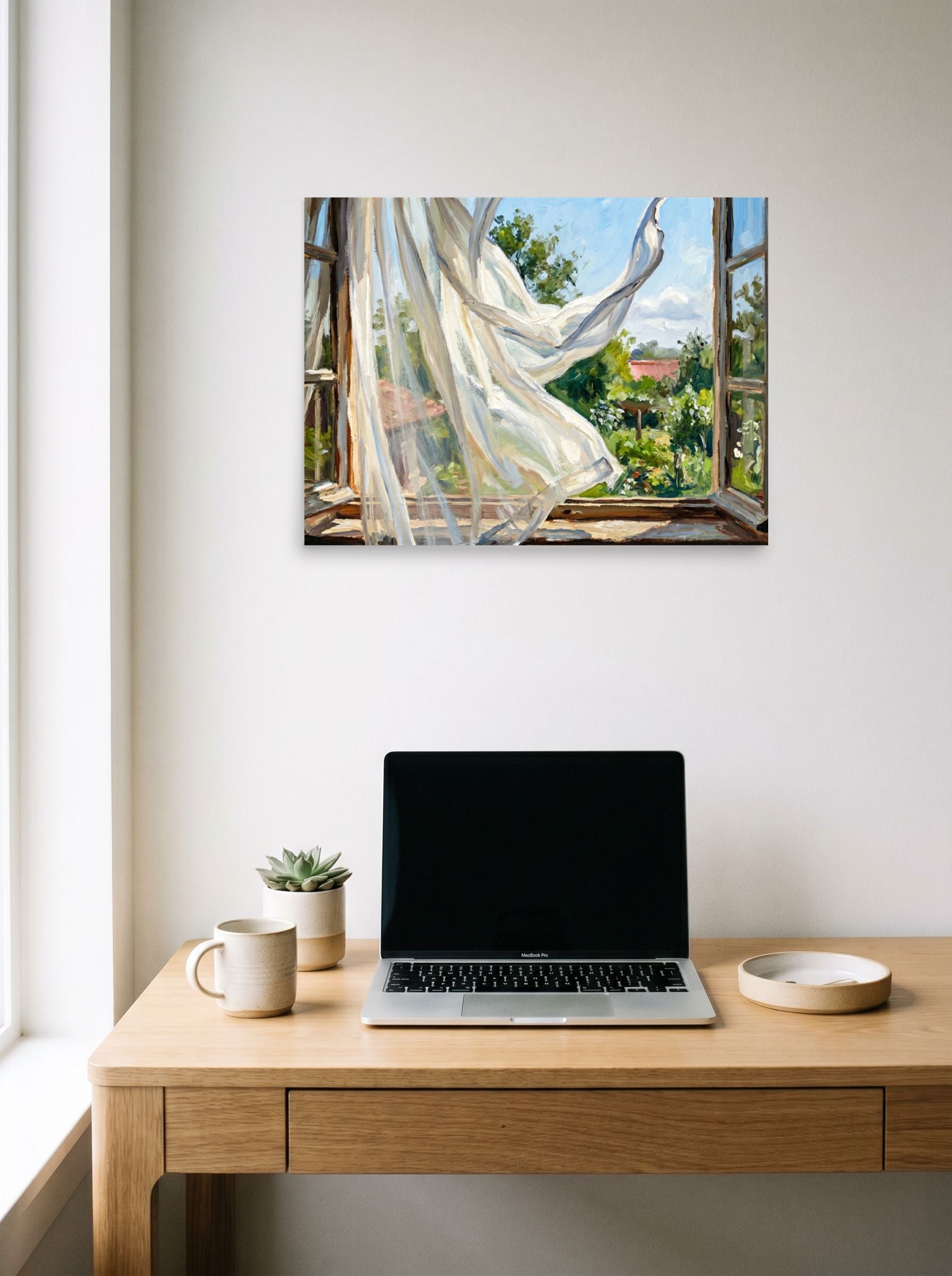 A 24x18 inch unframed paper Impressionism,Plein Air print of 'The Open Window' hanging above a worktable with a laptop.