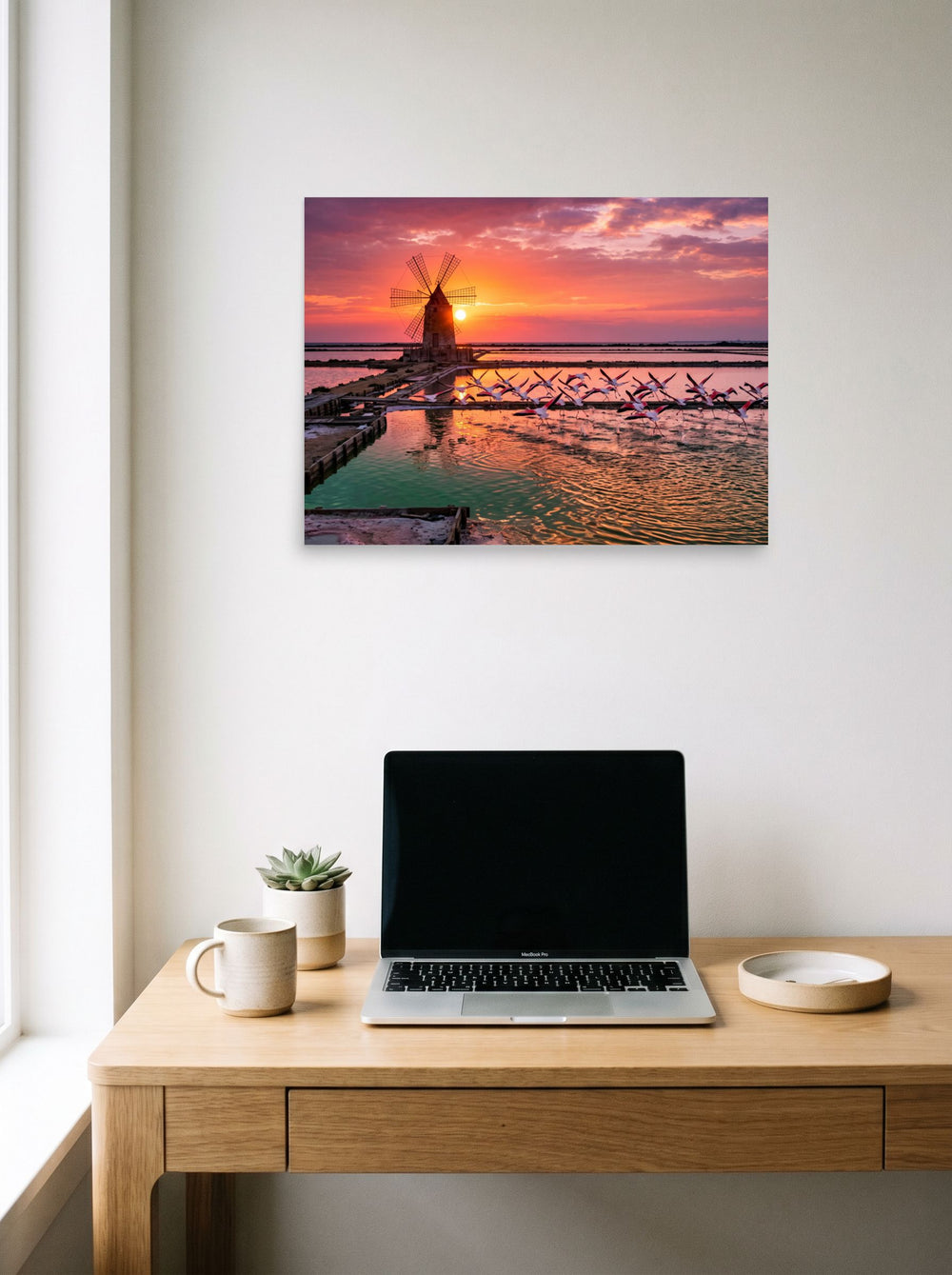 'Flamingos at Dusk' hanging above a worktable with a laptop, printed as unframed paper at 24x18 inch.