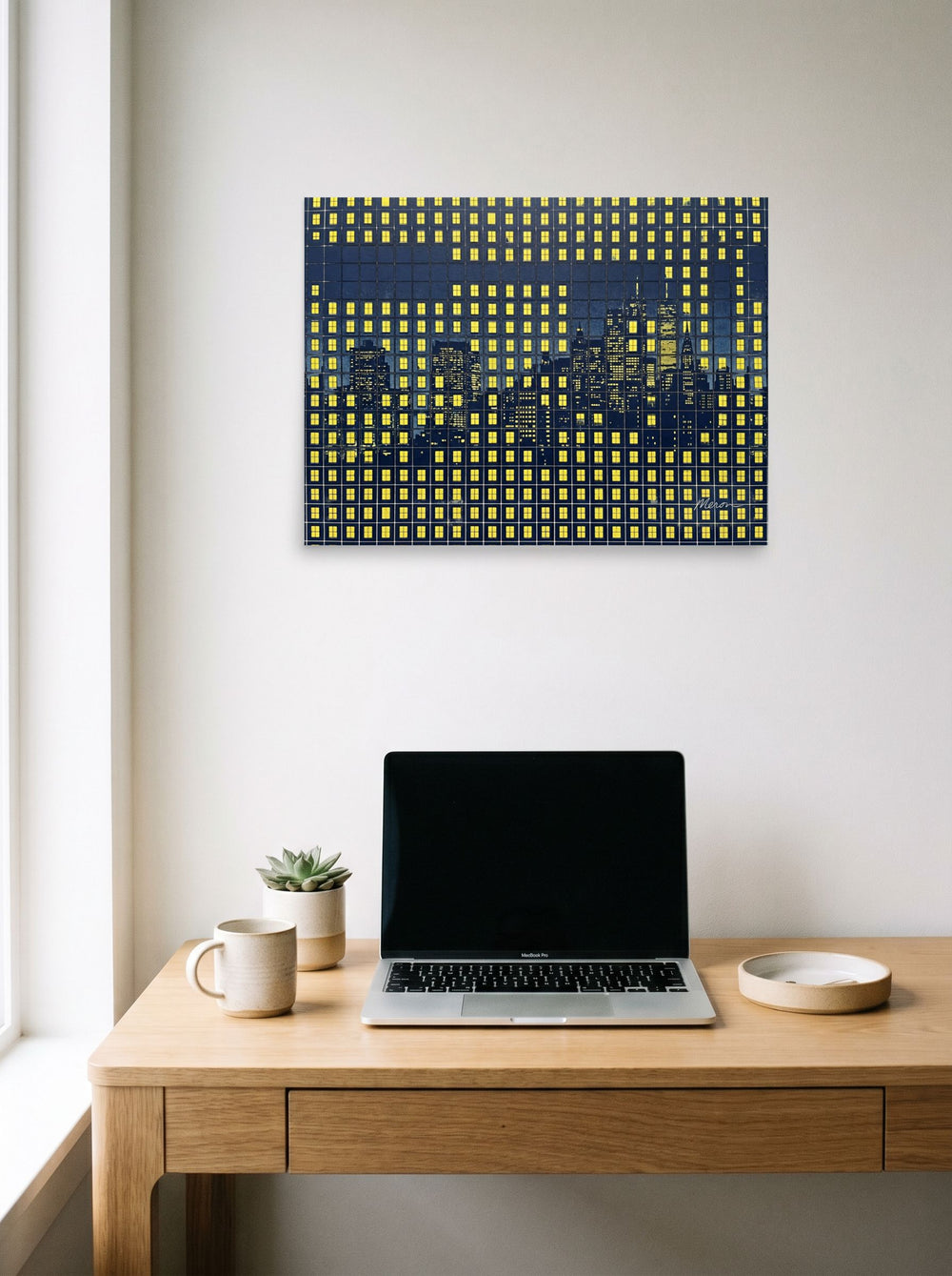 A 24x18 inch unframed paper Pop art print of 'Grid City Nights' hanging above a worktable with a laptop.
