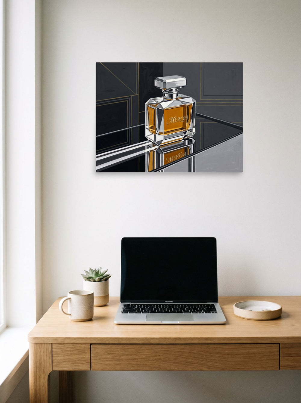 A 24x18 inch unframed paper Art Deco print of 'Deco Elixir' hanging above a worktable with a laptop.