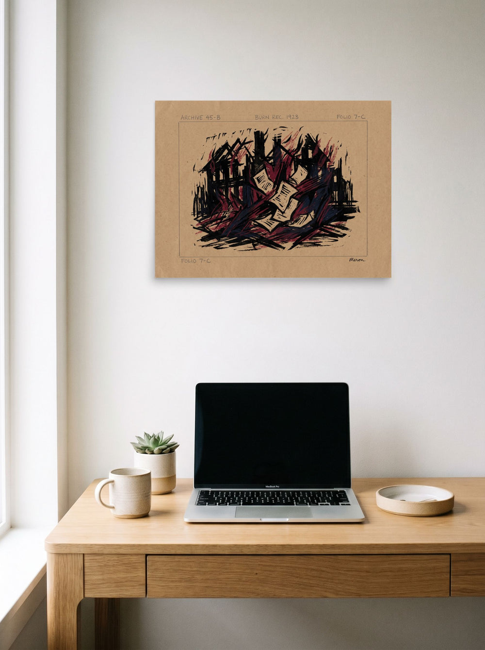 See 'Burn Record 1923' as a unframed paper print (24x18 inch), hanging above a worktable with a laptop.
