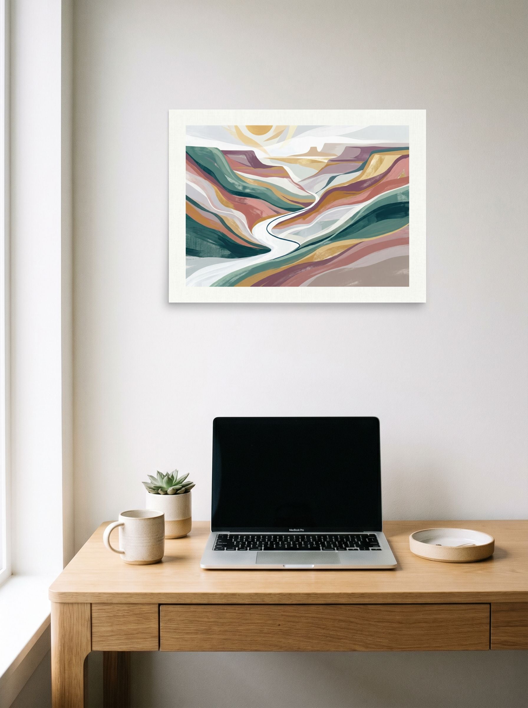 A 24x18 inch unframed paper Minimalism,American Scene Painting print of 'Winding Valley' hanging above a worktable with a laptop.