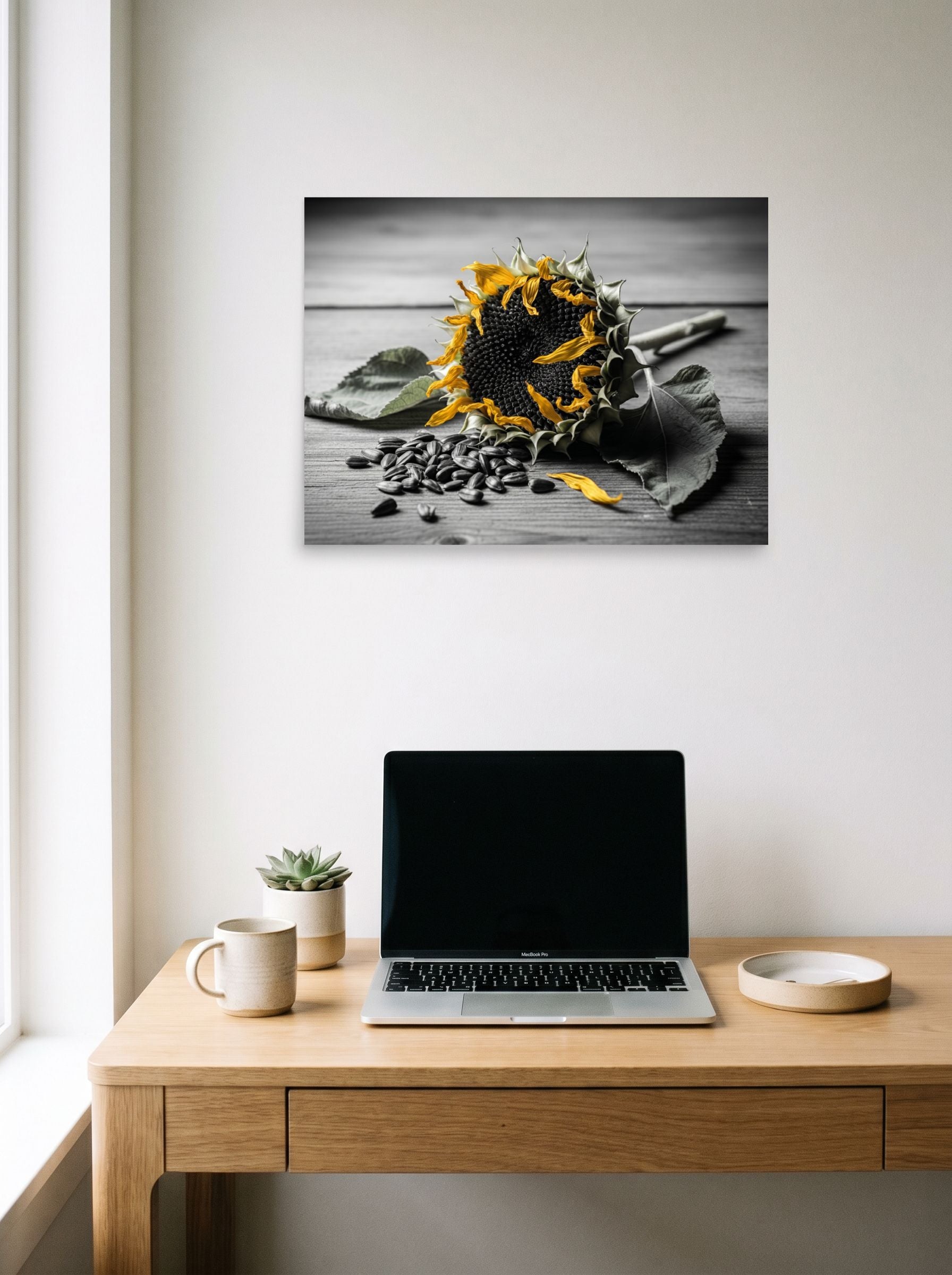 A 24x18 inch unframed paper Art photography print of 'Harvest Echoes' hanging above a worktable with a laptop.