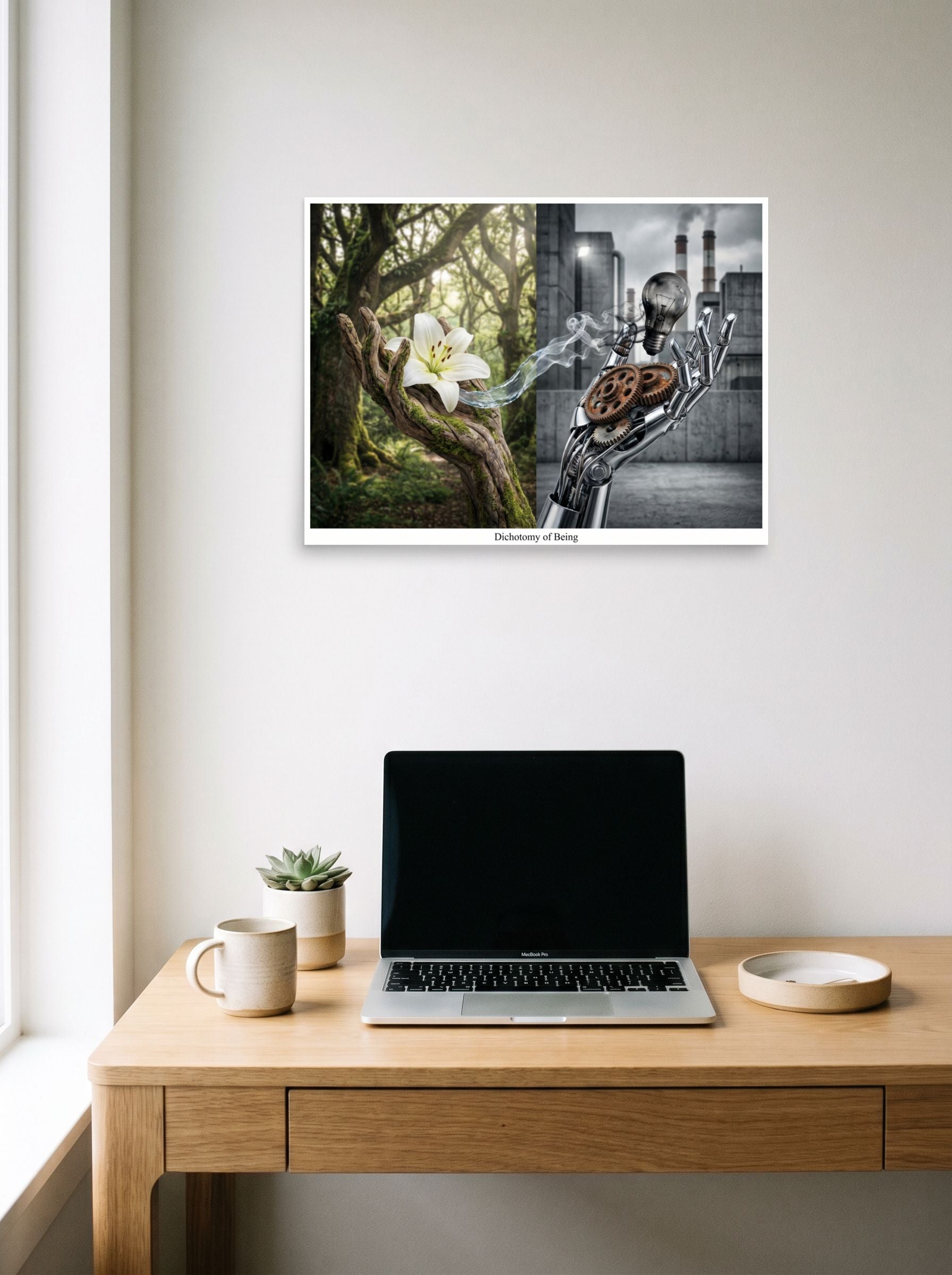 A 24x18 inch unframed paper Surrealism print of 'Dichotomy of Being' hanging above a worktable with a laptop.