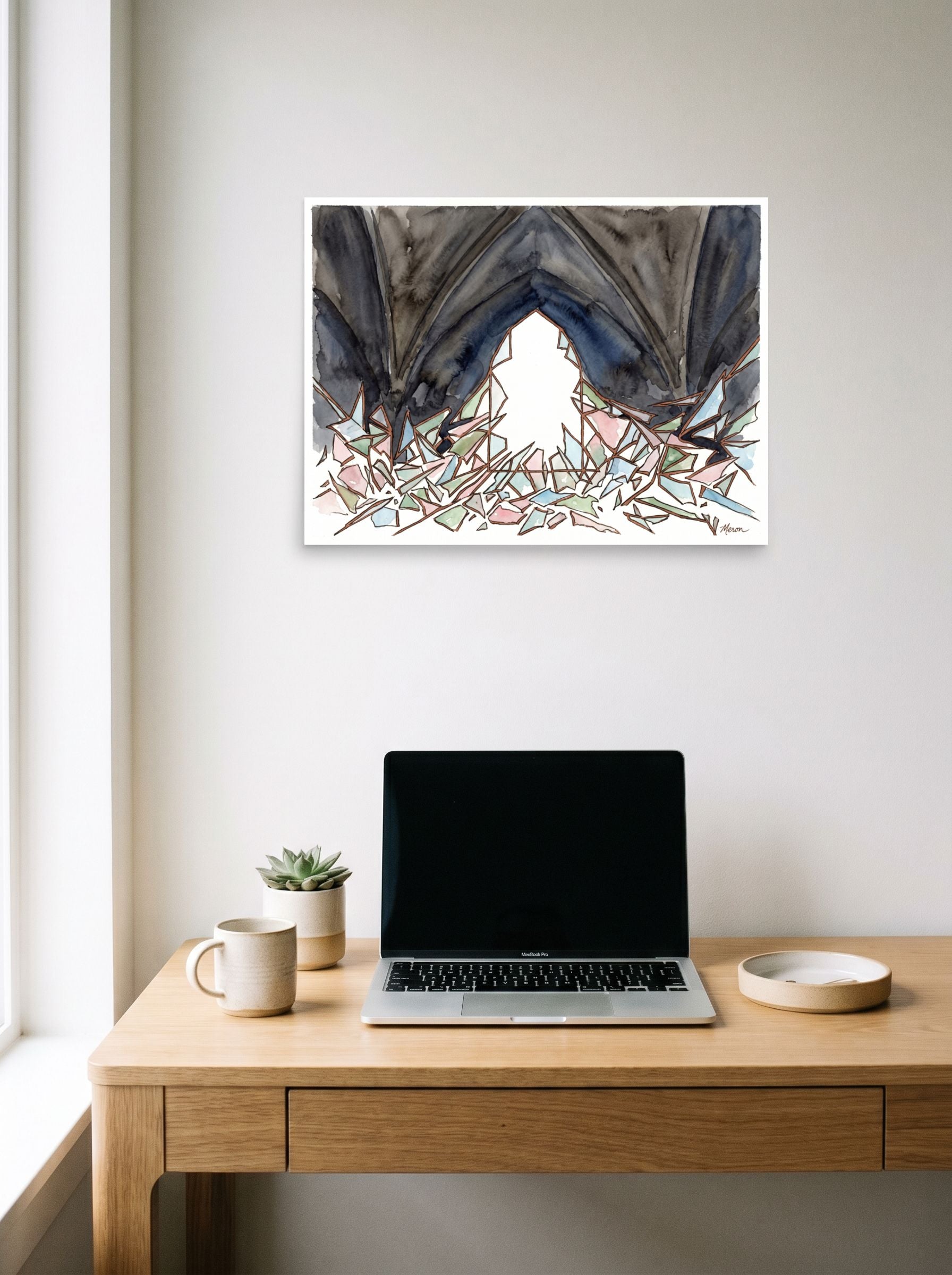 A 24x18 inch unframed paper Abstract expressionism print of 'The Shattered Window' hanging above a worktable with a laptop.
