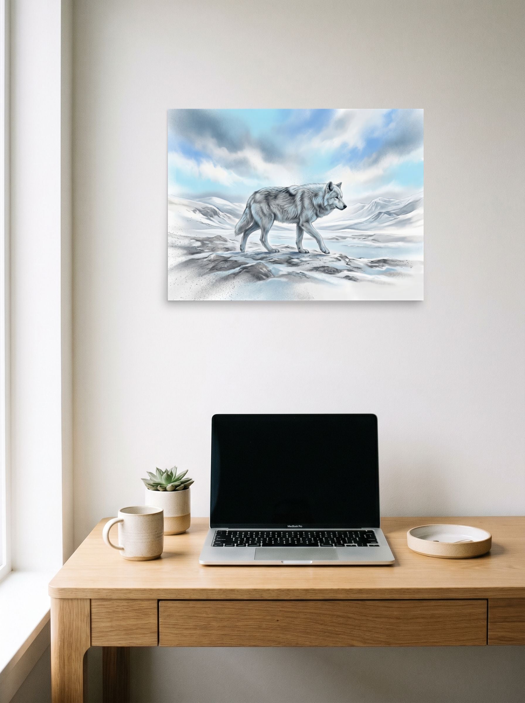 A 24x18 inch unframed paper Realism print of 'Solitary Frost' hanging above a worktable with a laptop.