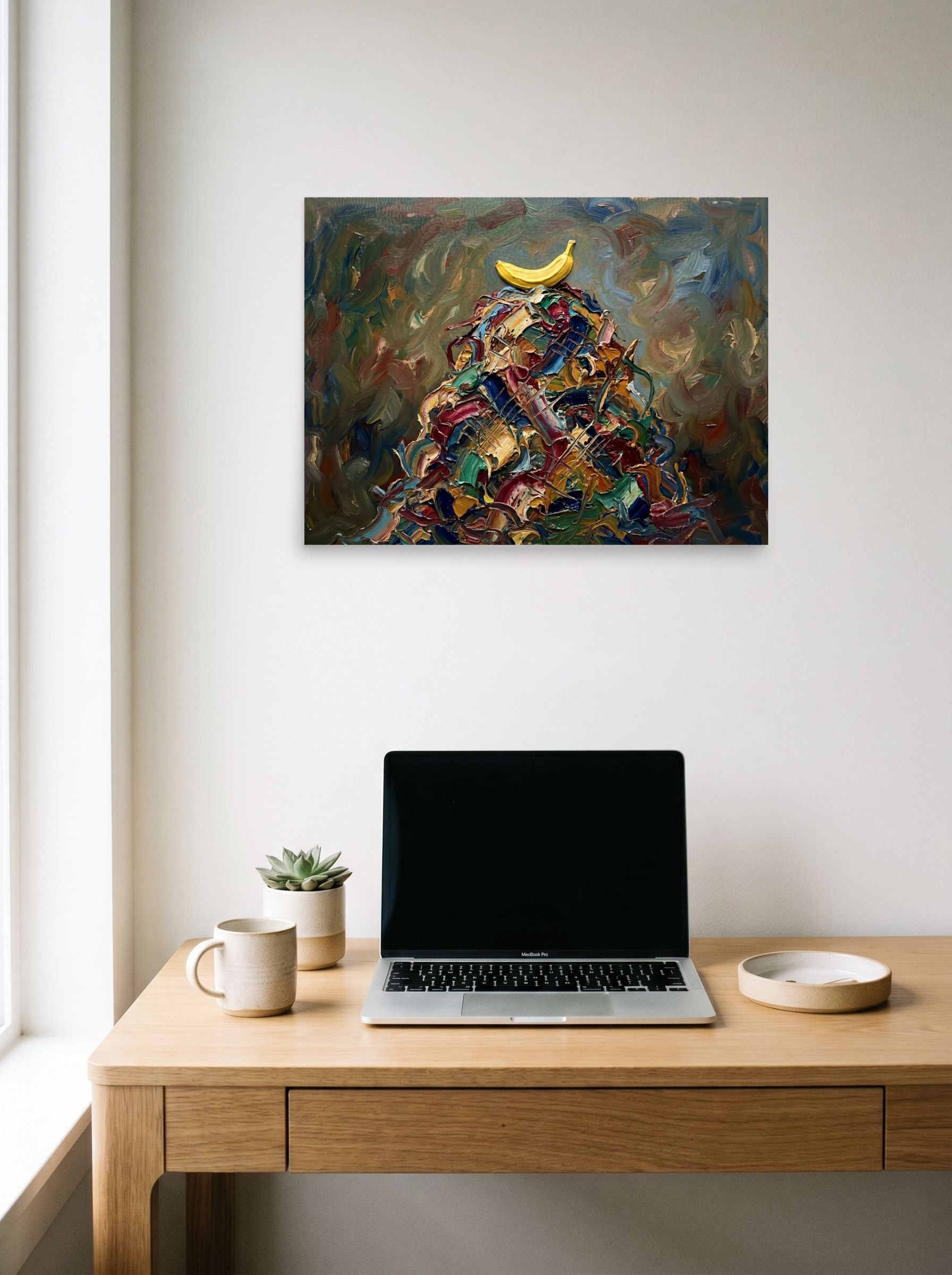 A 24x18 inch unframed paper Expressionism print of 'The Pinnacle' hanging above a worktable with a laptop.