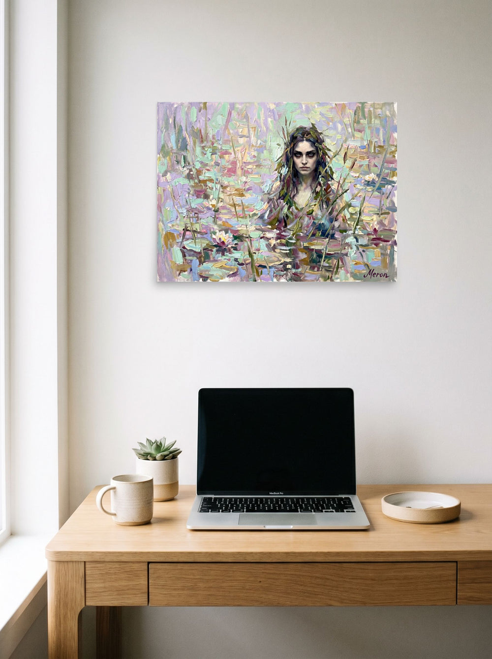 A 24x18 inch unframed paper Impressionism print of 'The Lily Nymph' hanging above a worktable with a laptop.
