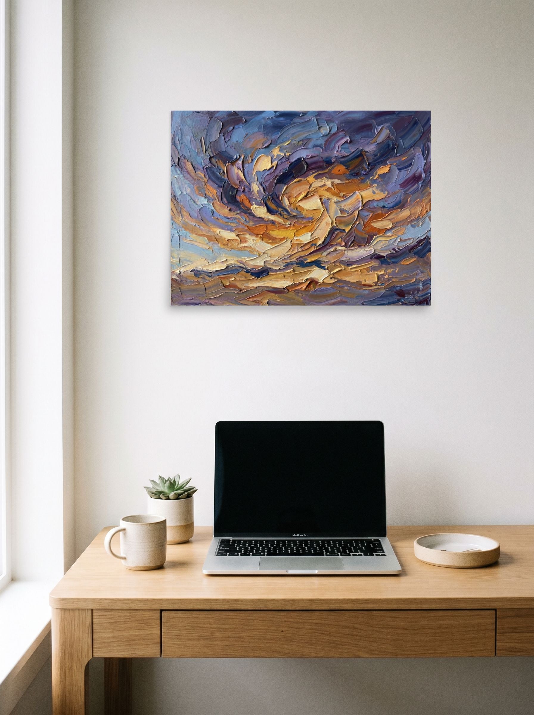 A 24x18 inch unframed paper Abstract expressionism print of 'Swirling Twilight Skies' hanging above a worktable with a laptop.