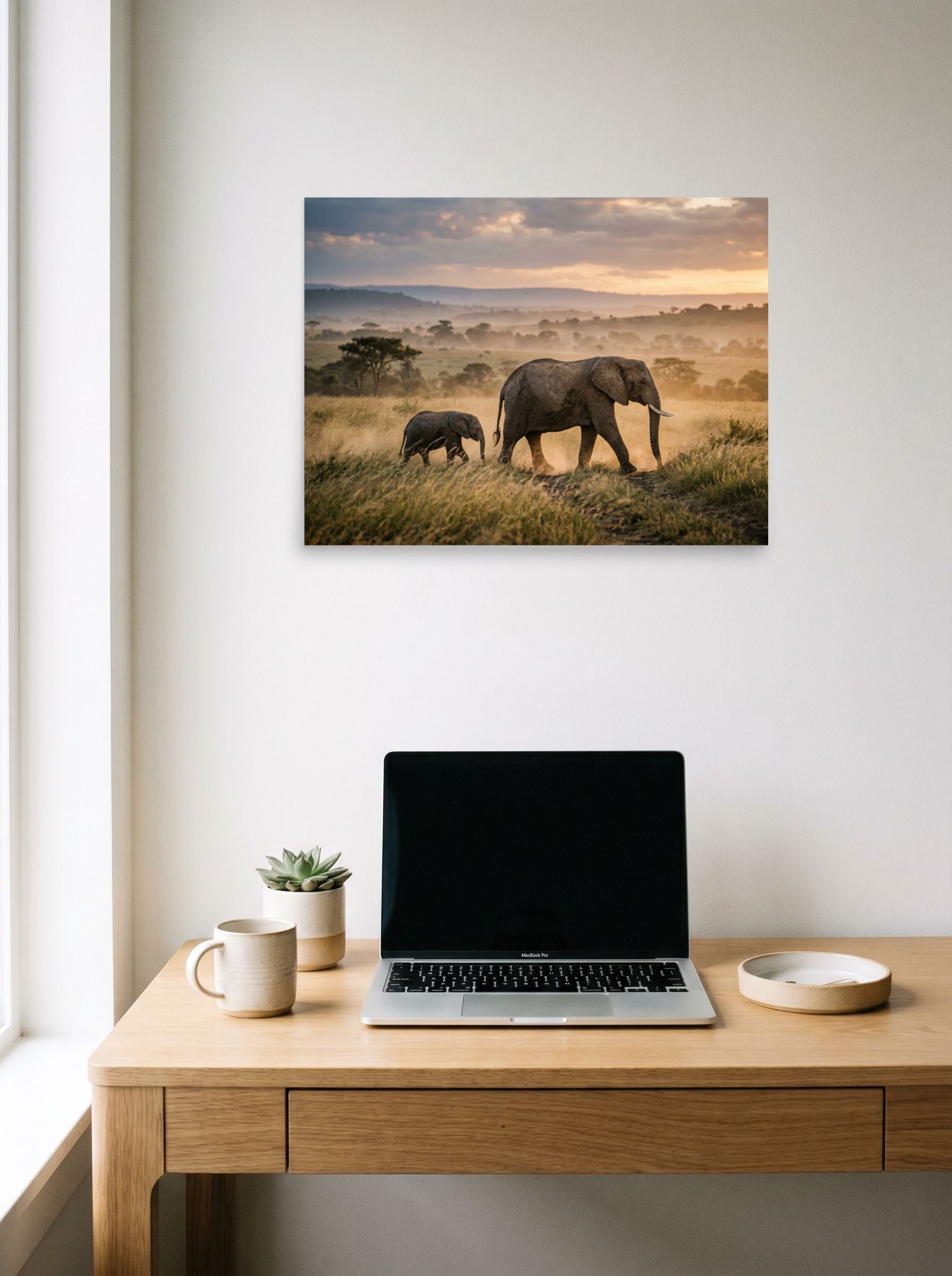 A 24x18 inch unframed paper Art photography print of 'Savannah Stroll' hanging above a worktable with a laptop.