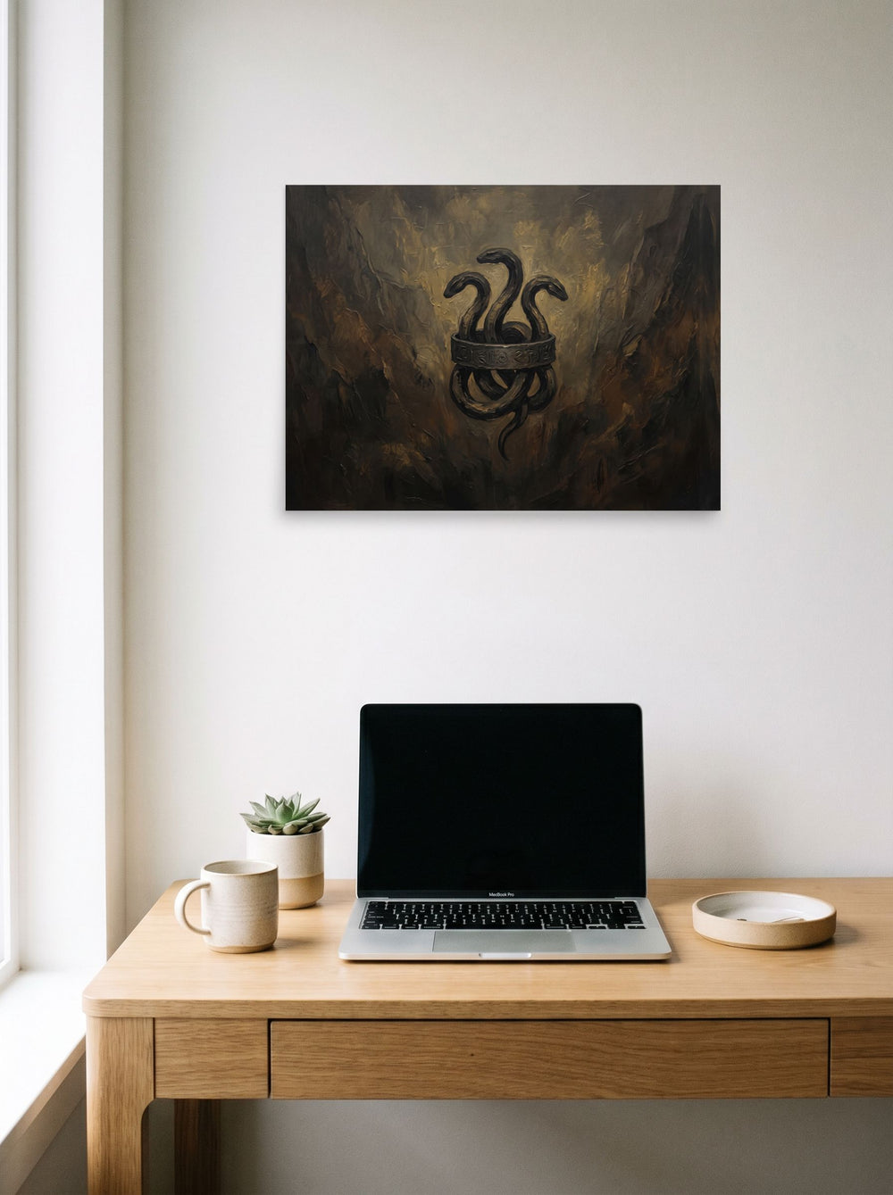 The Symbolism print 'Emblem of the Hydra', 24x18 inch unframed paper, hanging above a worktable with a laptop.