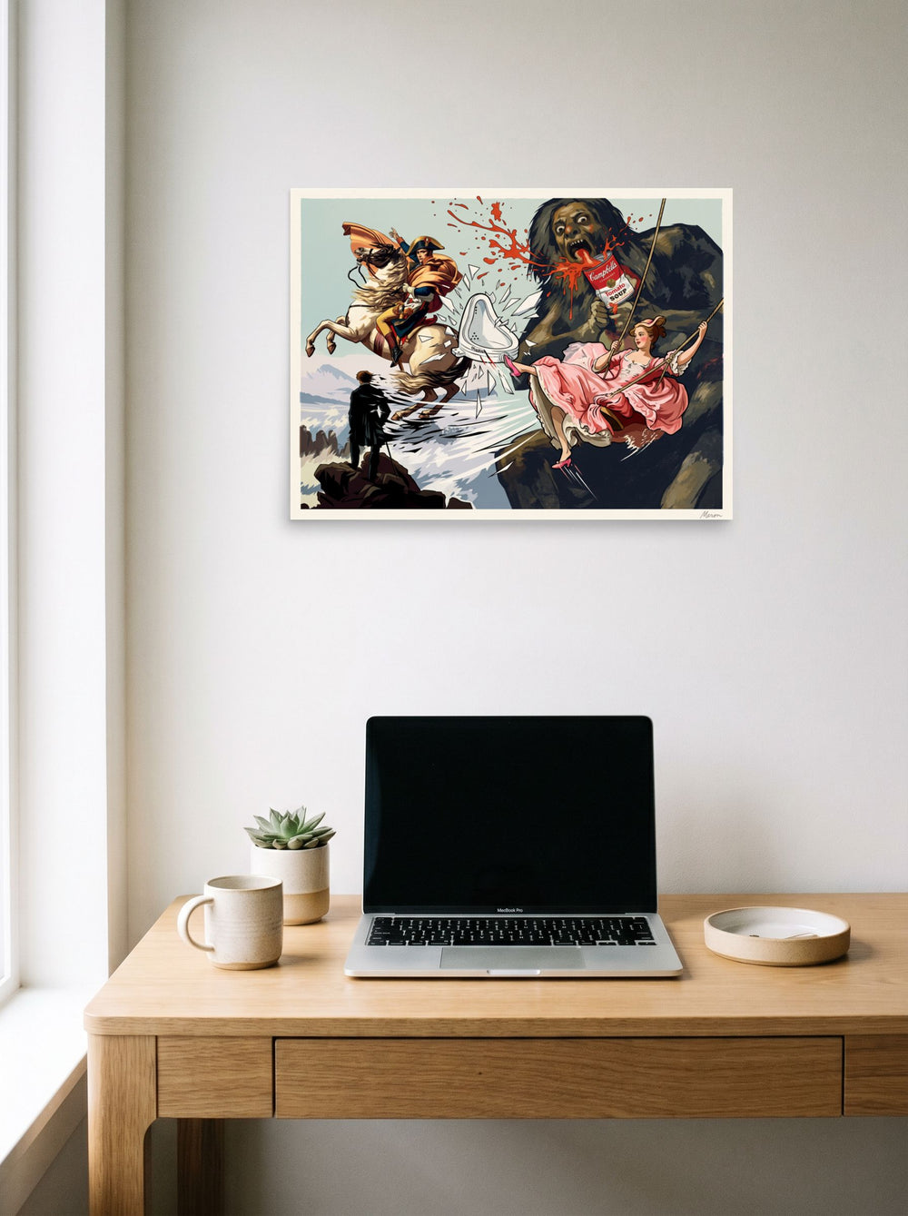 24x18 inch unframed paper print of 'Saturn's Soup', hanging above a worktable with a laptop.