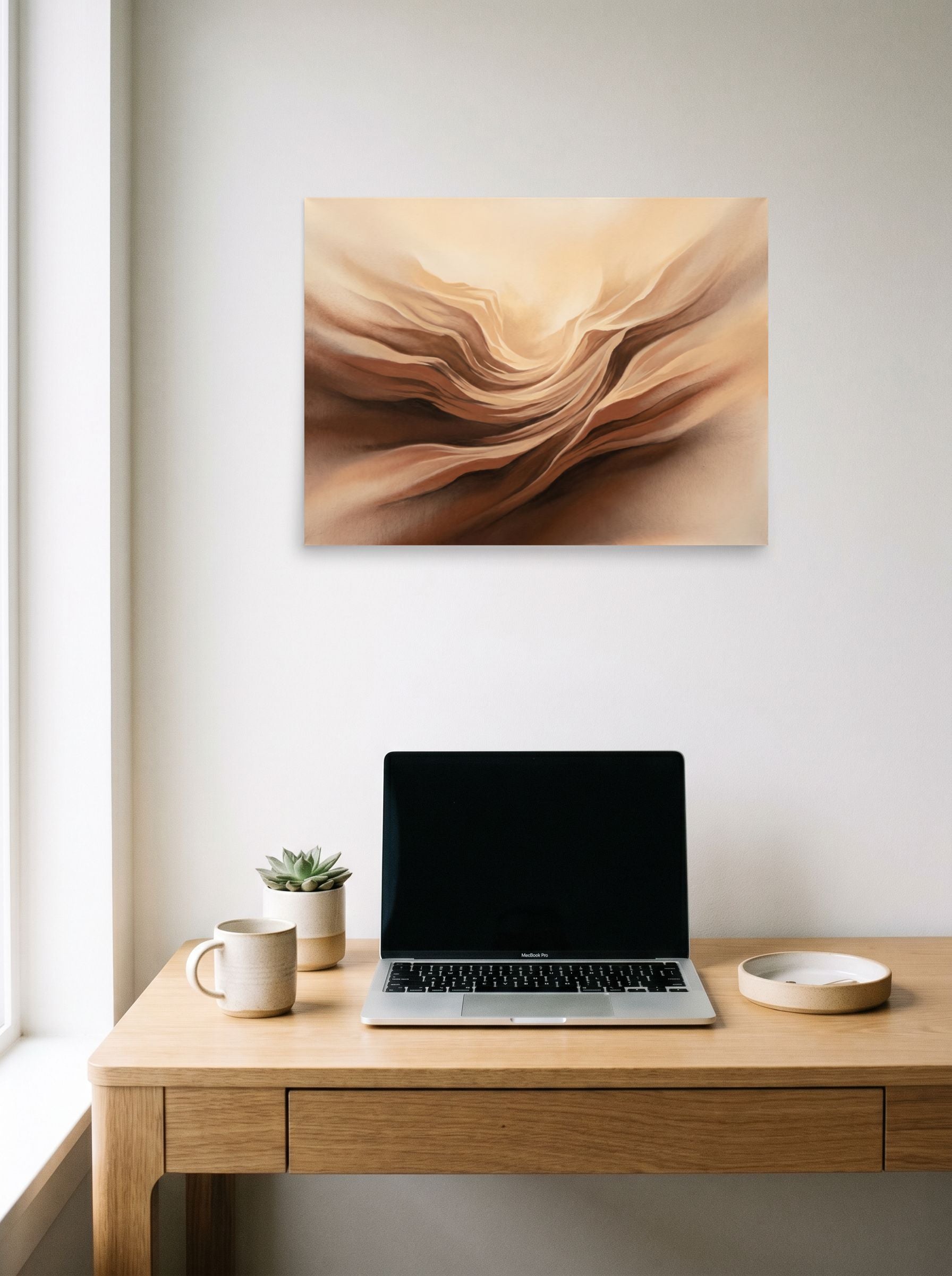 A 24x18 inch unframed paper Abstract art print of 'Earthly Folds' hanging above a worktable with a laptop.