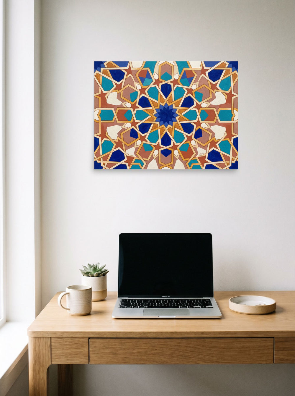 Mockup of 'The Andalusian Star' as a 24x18 inch unframed paper print, hanging above a worktable with a laptop.